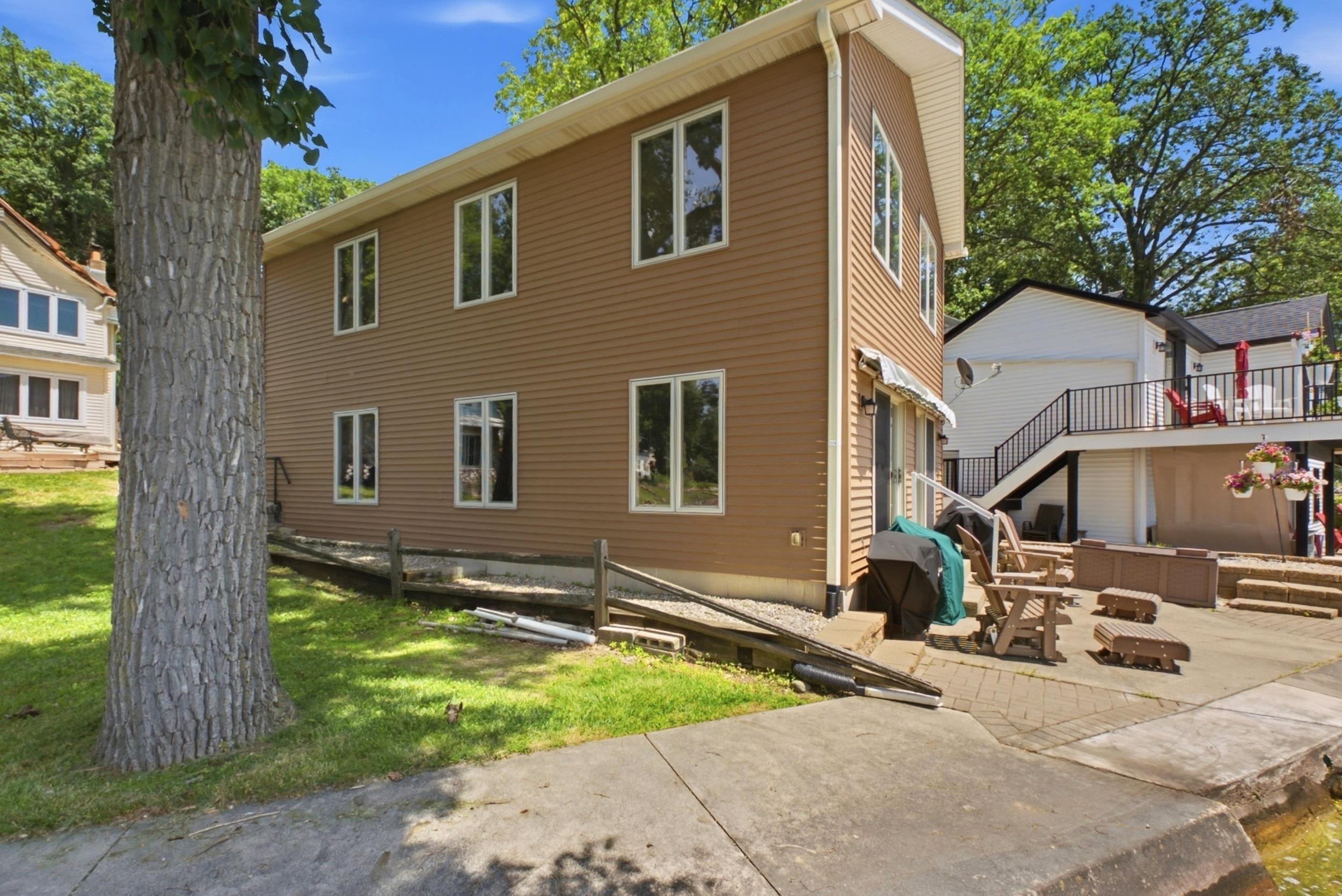 Image 2: Two-story property featuring brown siding and multiple windows, Side Of Structure Image 2: Two-story property featuring brown siding and multiple windows, Side Of Structure