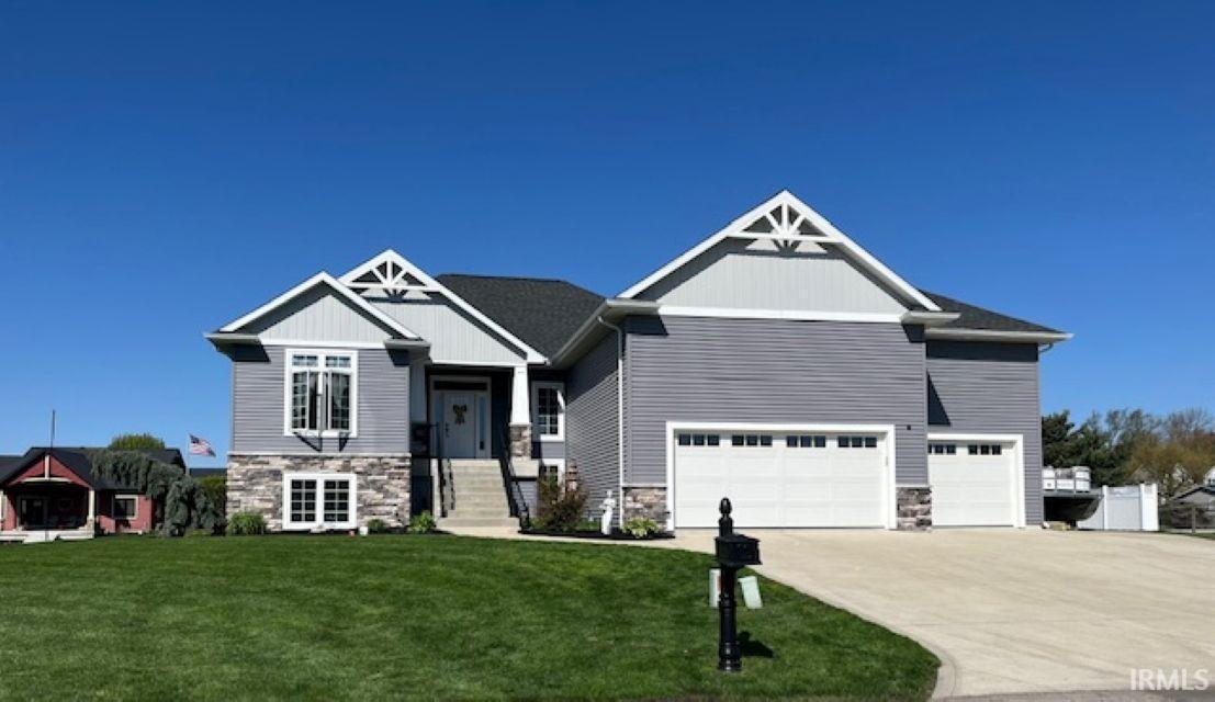 Image 1: Contemporary home featuring a stone and siding exterior, multi-pane windows, and an attached two-car garage, Front Of Structure