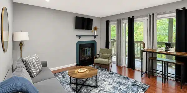 Image 2: Recessed lighting, wood-finish flooring, fireplace with decorative mantel, and multiple sliding glass doors leading to an outdoor deck, Living Room Image 2: Recessed lighting, wood-finish flooring, fireplace with decorative mantel, and multiple sliding glass doors leading to an outdoor deck, Living Room