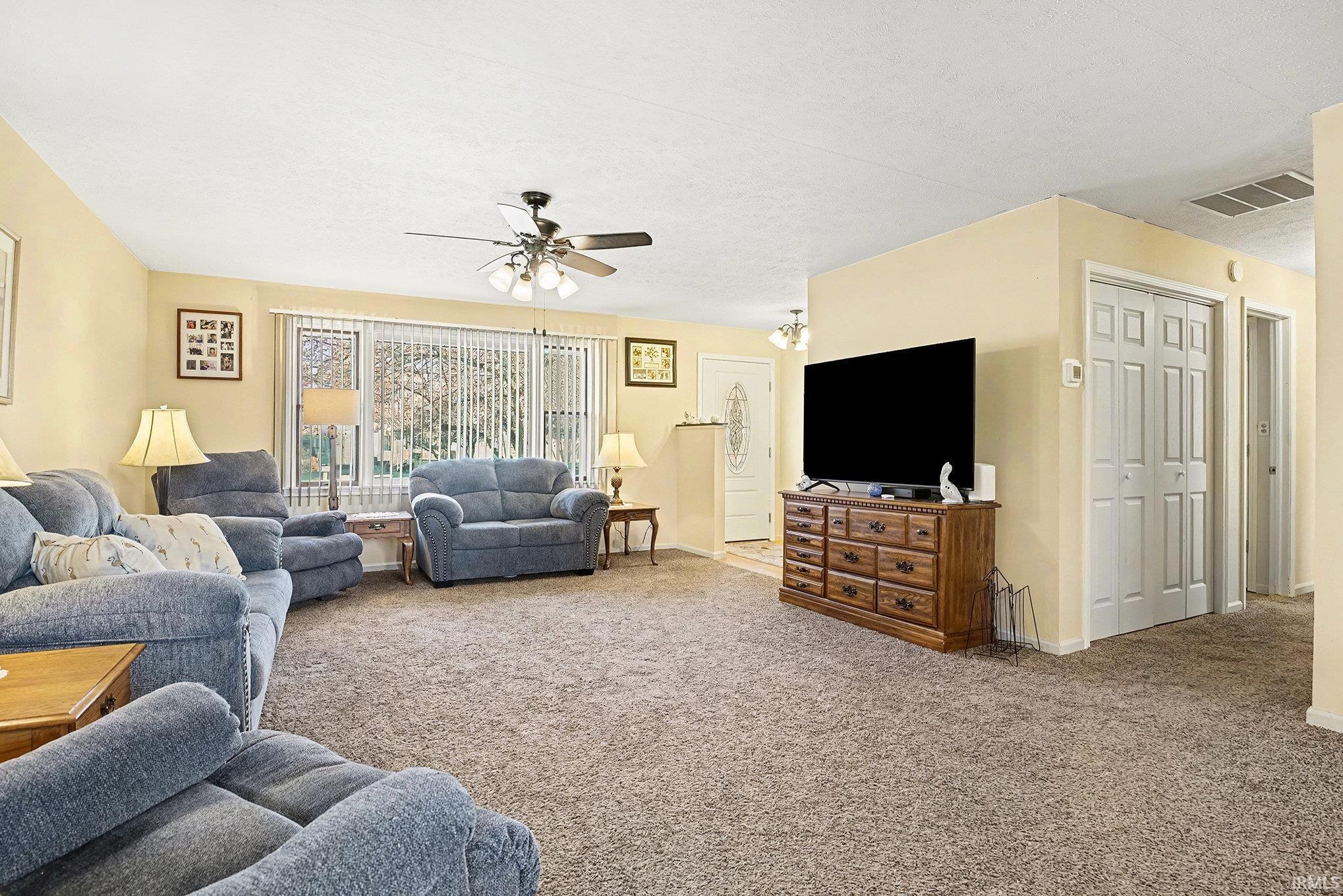 Image 1: Living room featuring carpet flooring, a ceiling fan, and a textured ceiling, Living Room