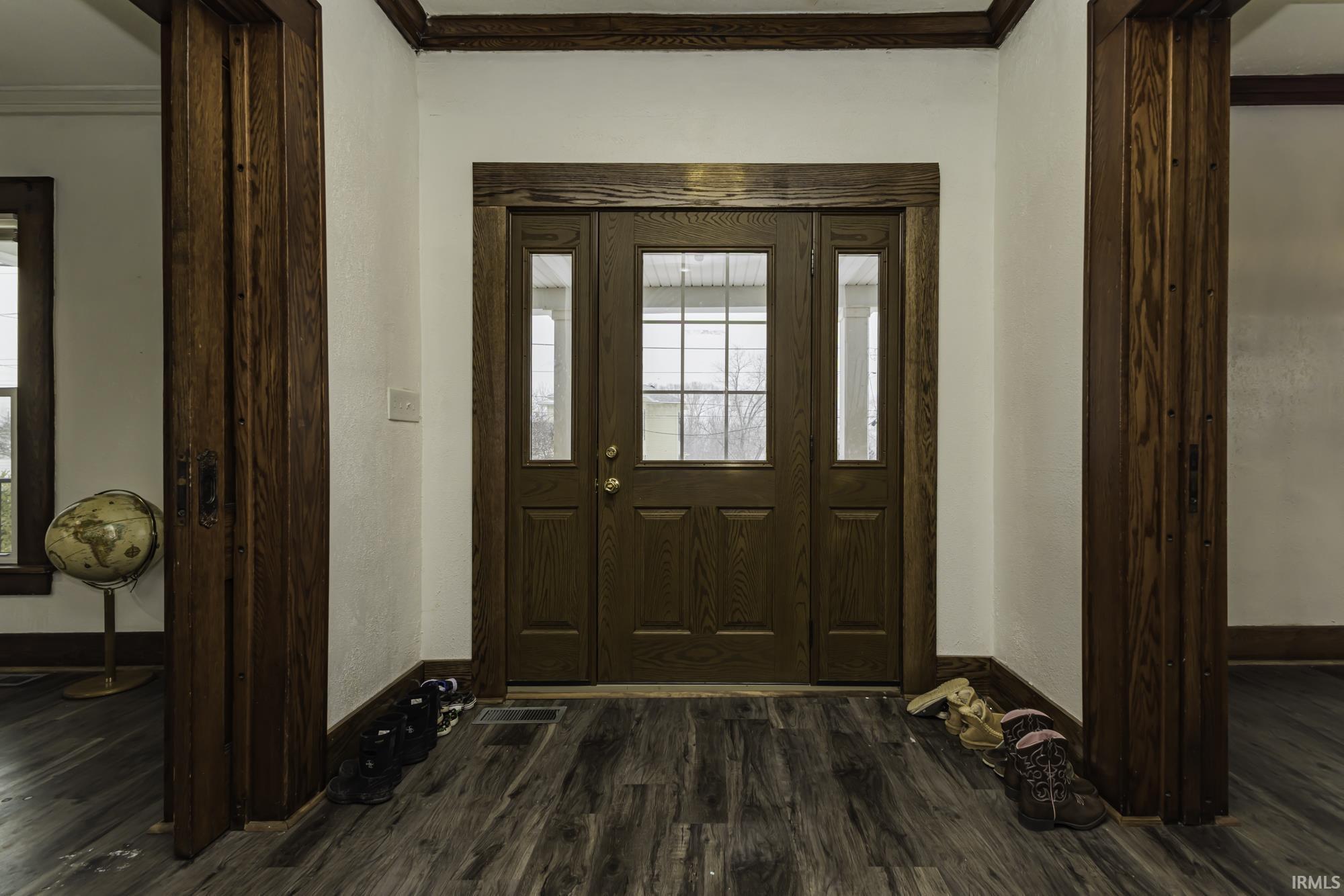 Image 2: Entryway with dark wood-type flooring and ornamental molding, Entrance Foyer