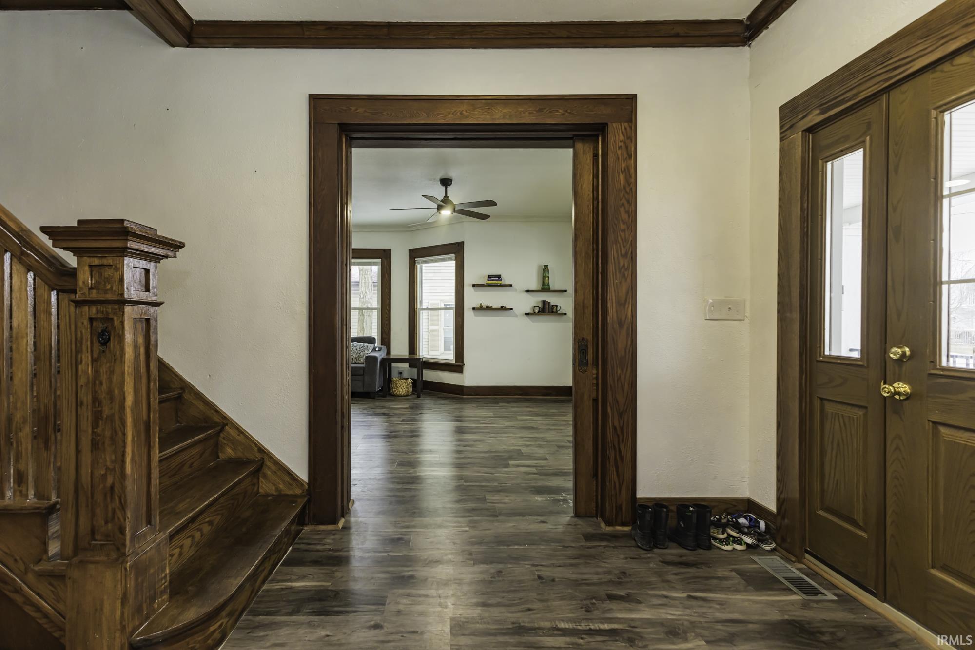 Image 3: Entryway featuring ornamental molding, stairway, dark wood-style flooring, and ceiling fan, Entrance Foyer