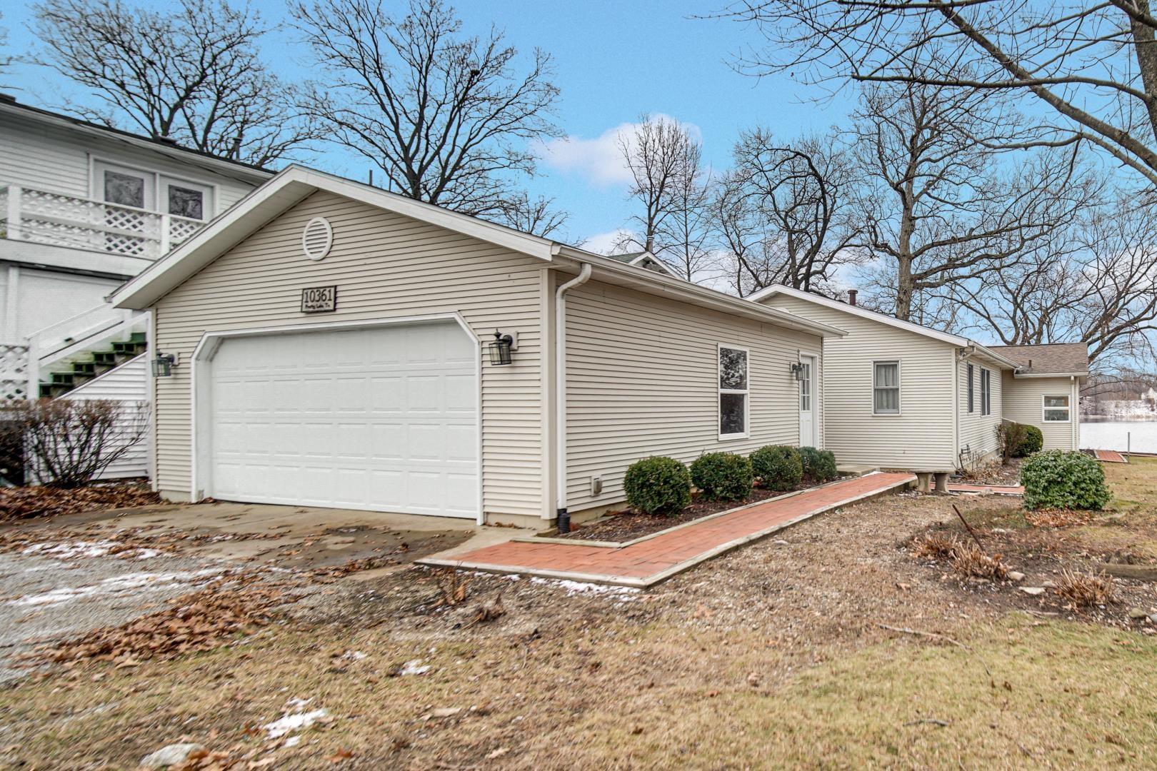 Image 0: View of property exterior featuring concrete driveway and a garage, Back of home