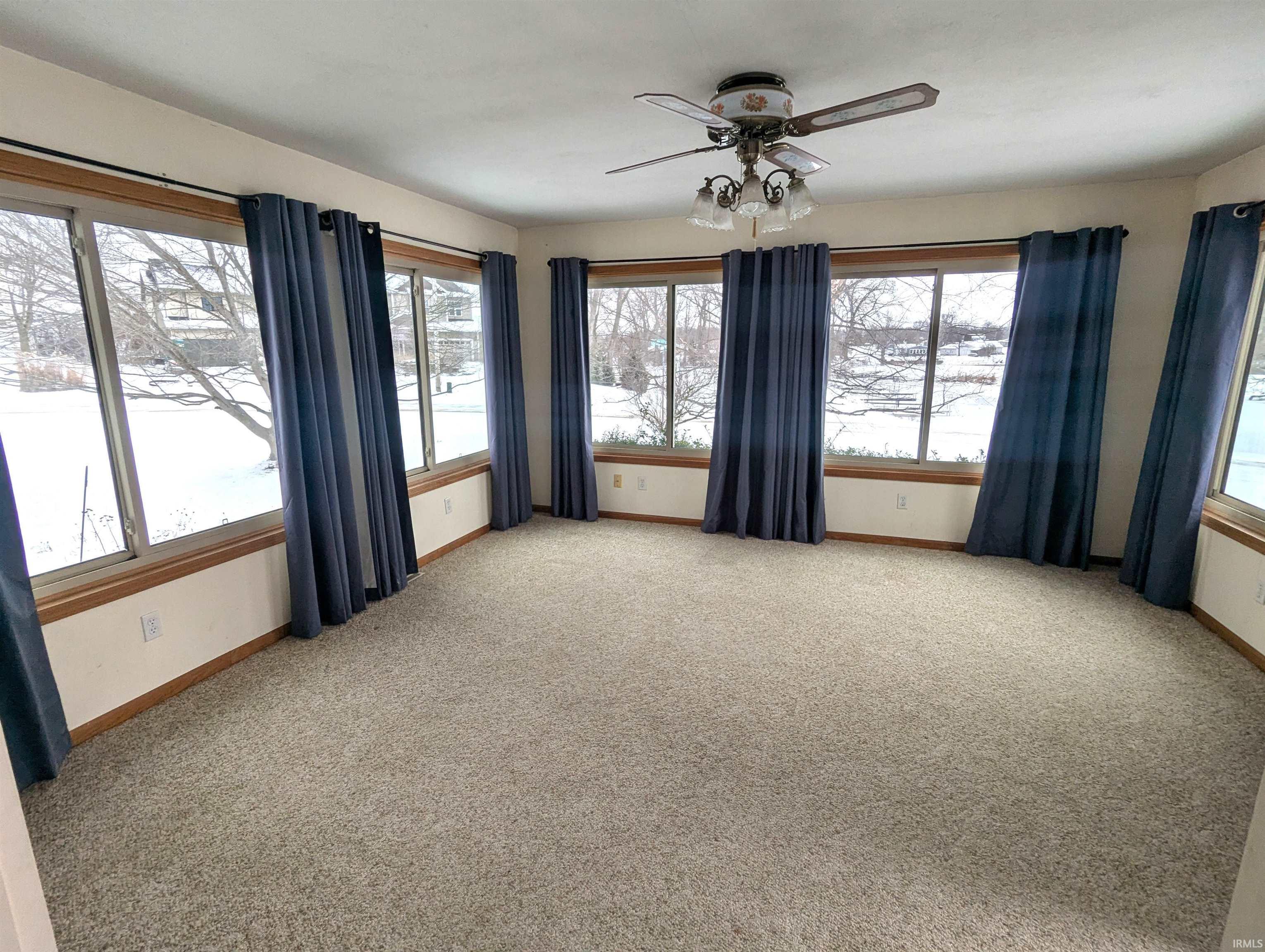 Image 2: Wrap around windows room featuring light carpet and a ceiling fan, 4 Season Room