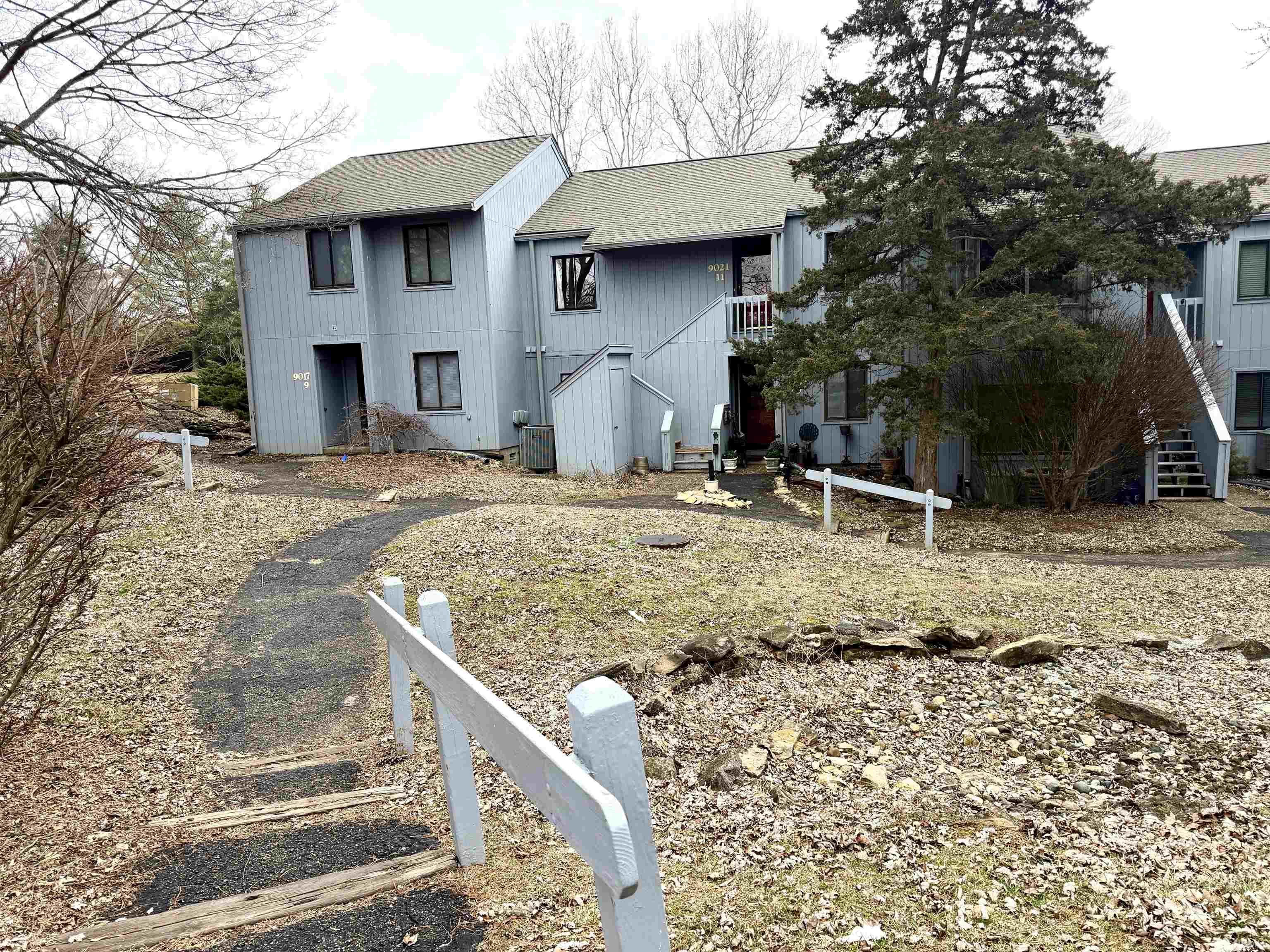 Image 0: Rear view of house with stairs and roof with shingles, Back Of Structure