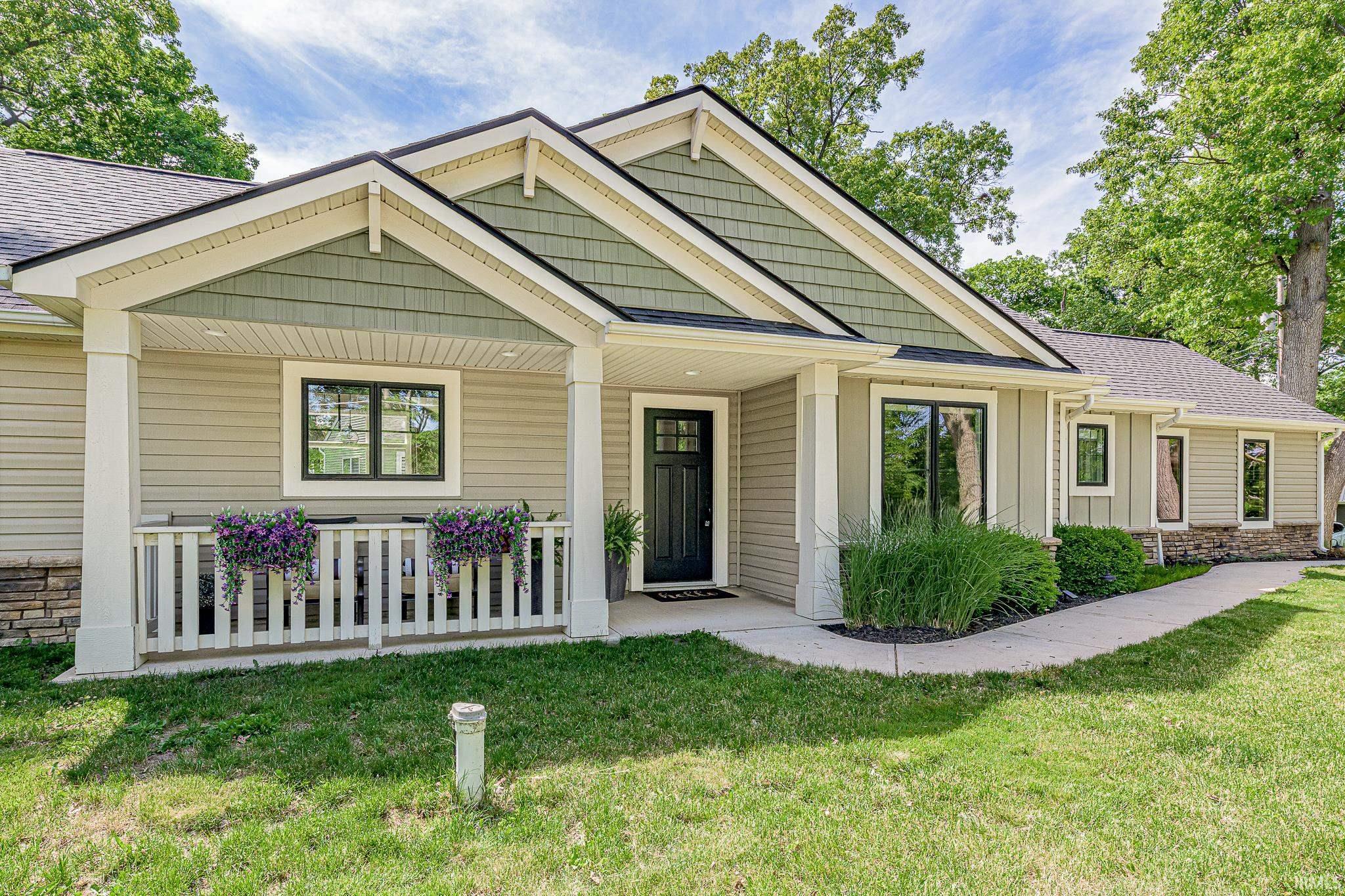 Image 1: Contemporary ranch-style home featuring a covered front porch, a gabled roofline with shake siding, horizontal siding, and stone accents, Front Of Structure