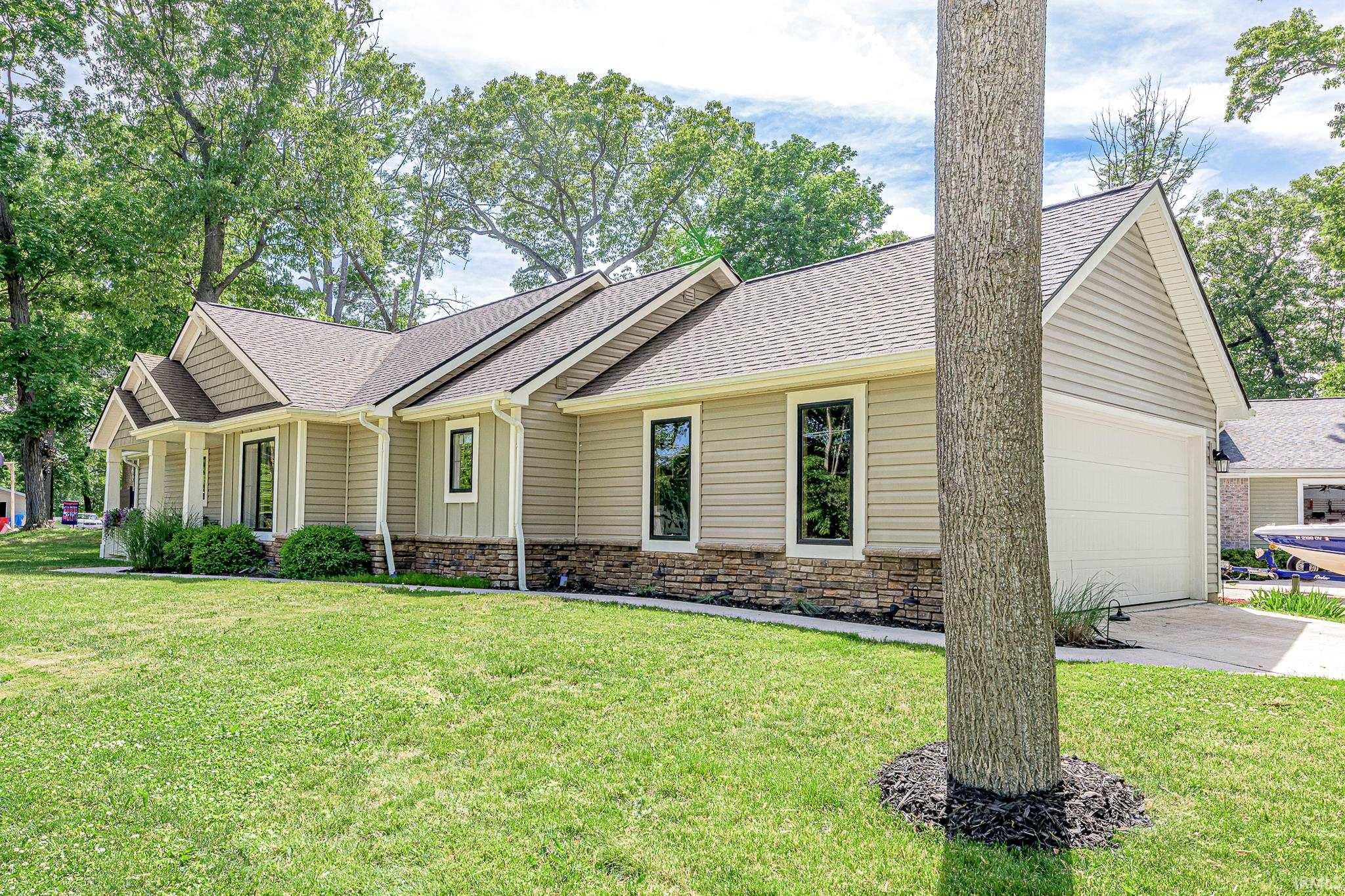 Image 3: Exterior featuring horizontal siding, vertical accents, and a stone veneer foundation, Front Of Structure