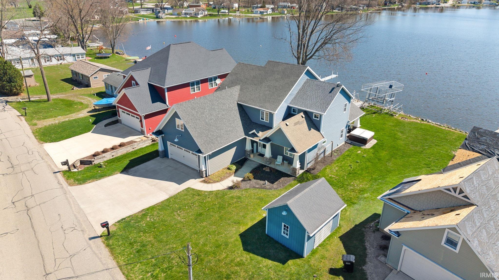 Image 2: Aerial perspective of suburban area featuring a large body of water, Aerial View
