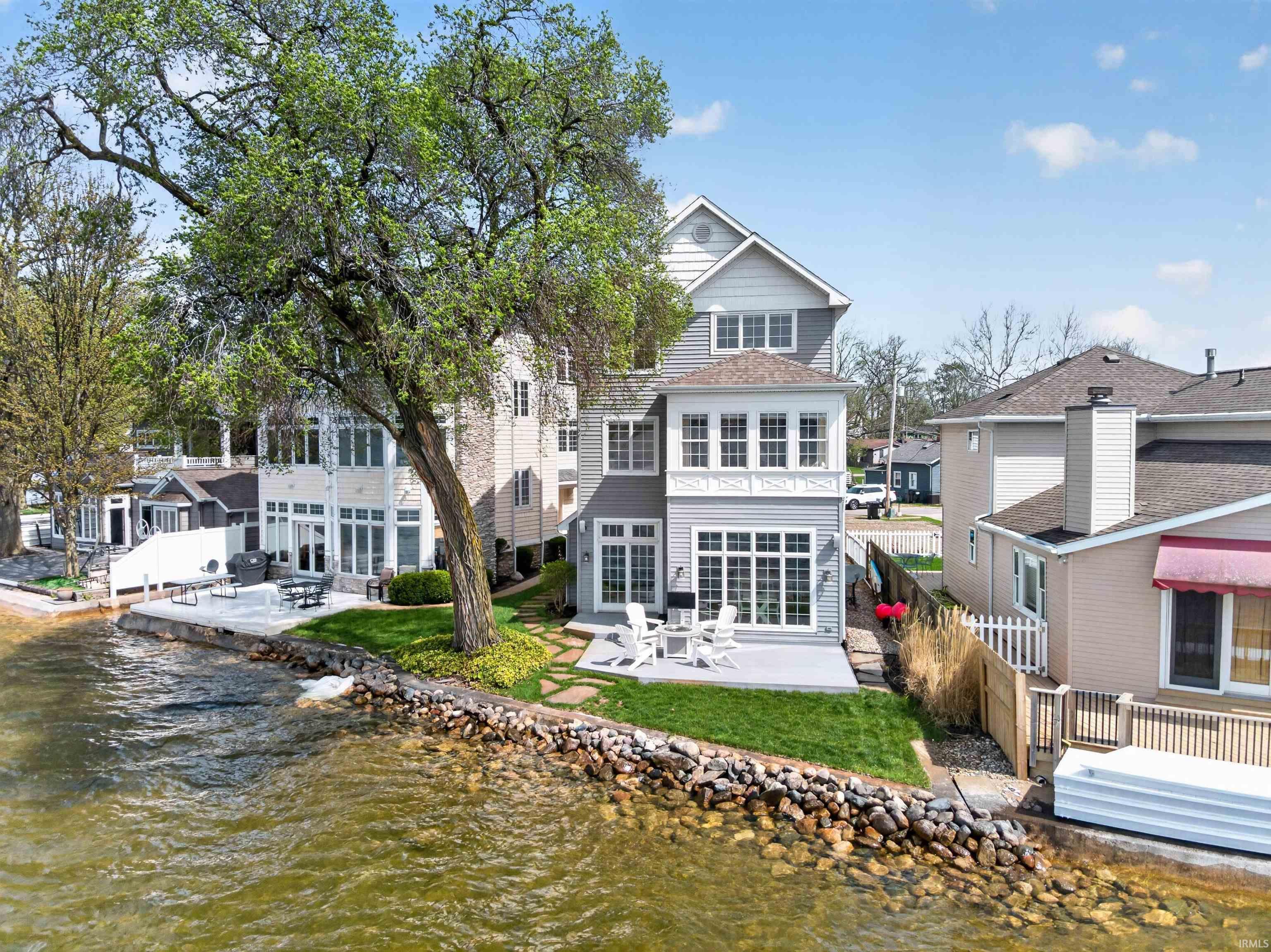 Image 0: Rear view of house with a patio and a water view, Back Of Structure Image 0: Rear view of house with a patio and a water view, Back Of Structure