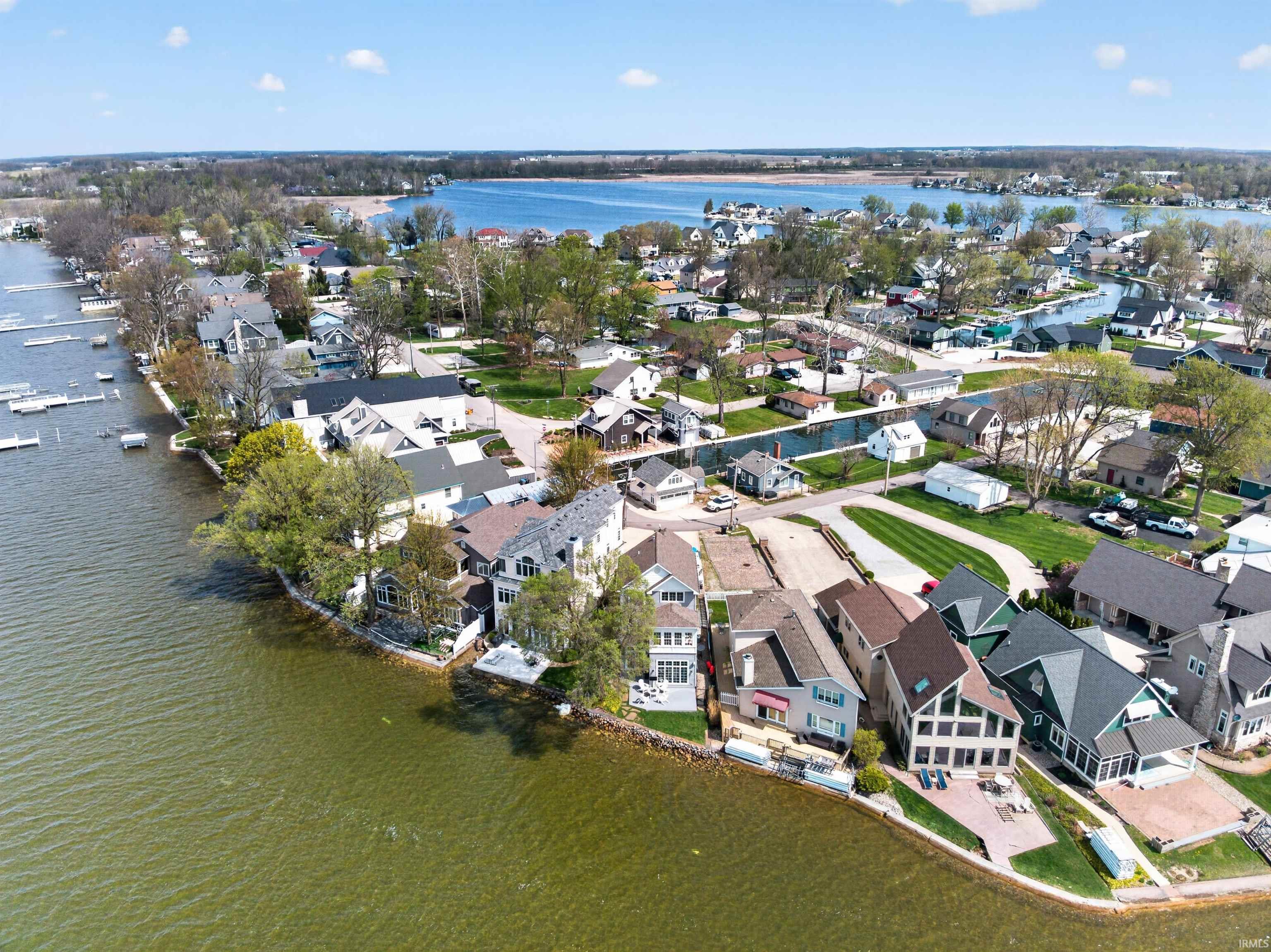 Image 1: Aerial overview of property's location featuring a large body of water and nearby suburban area, Aerial View Image 1: Aerial overview of property's location featuring a large body of water and nearby suburban area, Aerial View