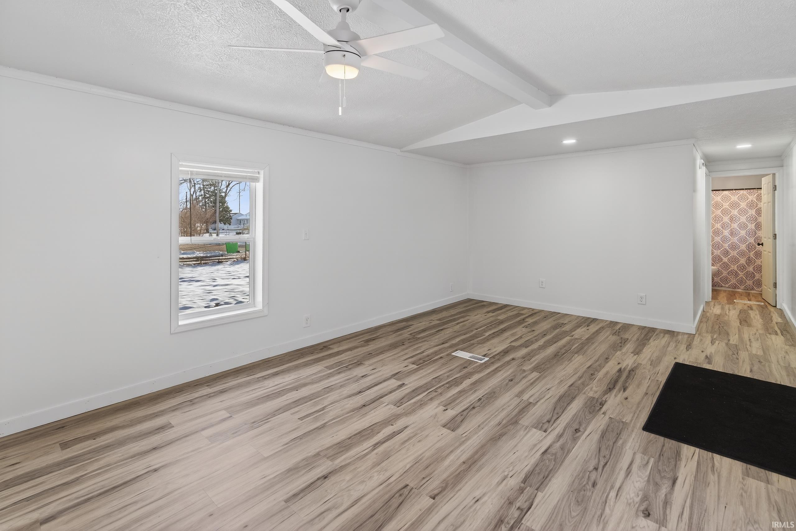 Image 2: Spare room featuring light wood-type flooring, a textured ceiling, ceiling fan, and ornamental molding, Other