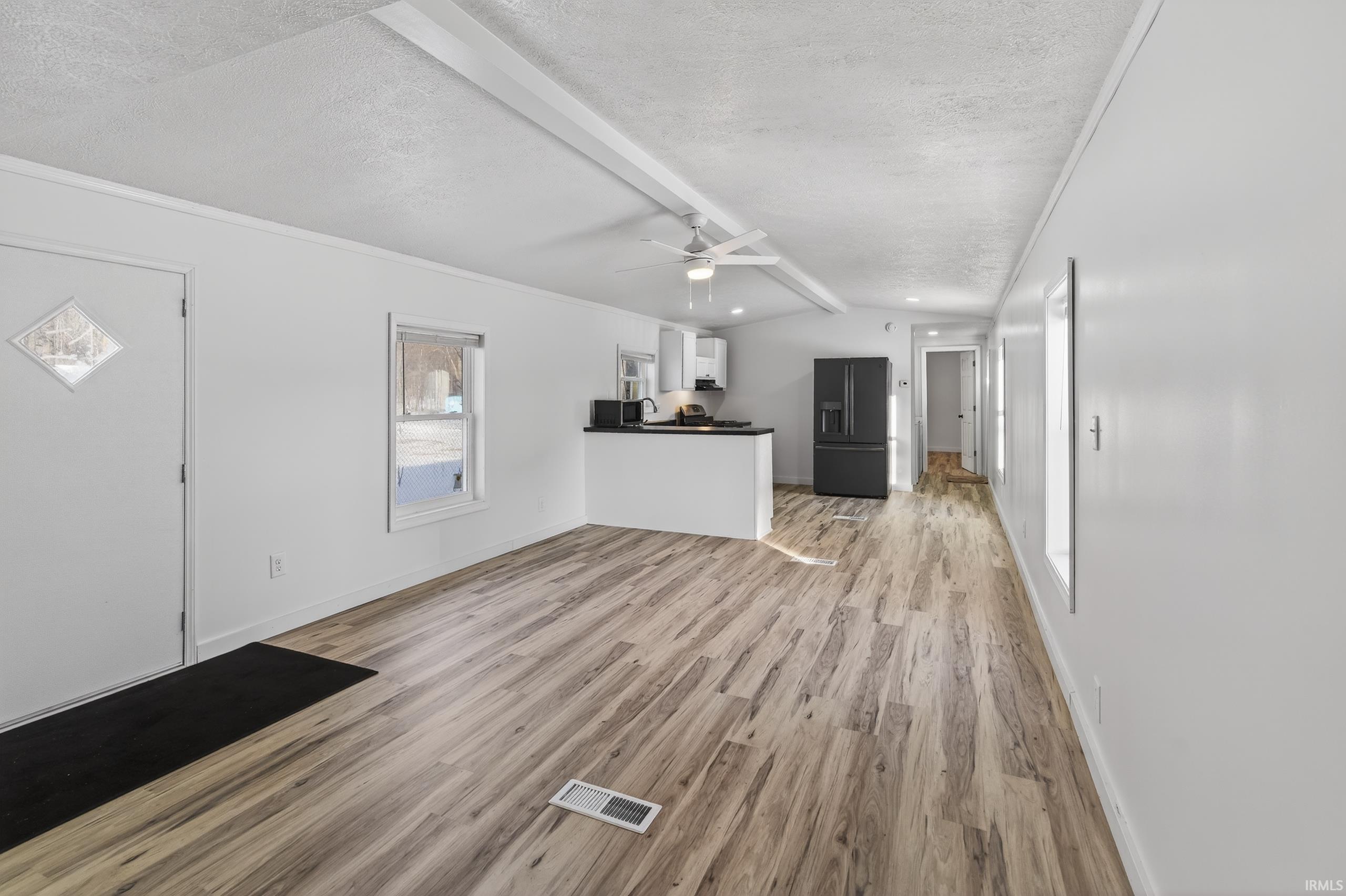 Image 3: Unfurnished living room featuring light wood-style flooring, ceiling fan, and a textured ceiling, Living Room