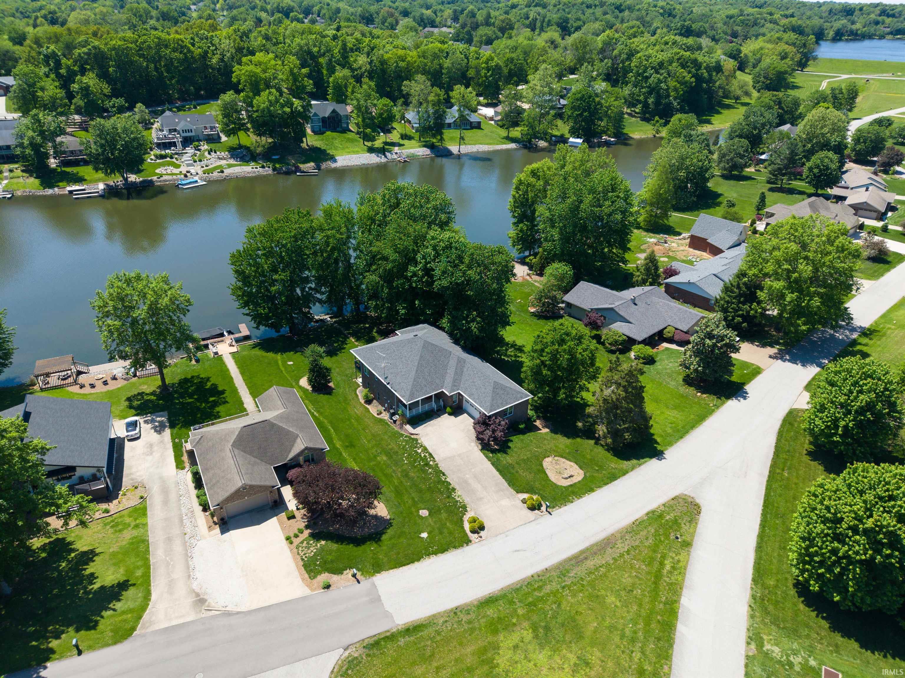 Image 1: Aerial perspective highlighting a residential property with direct waterfront access, Aerial View