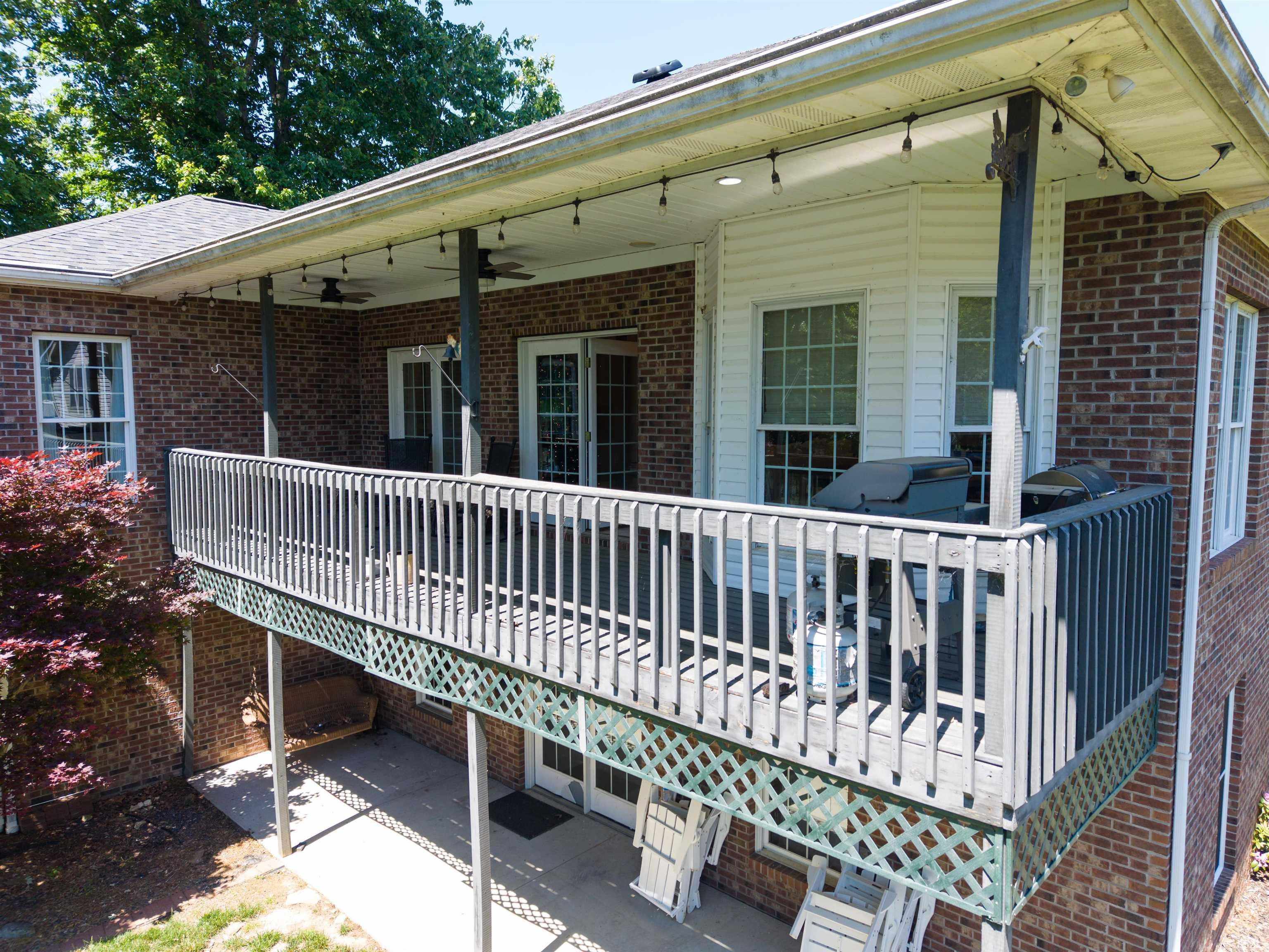 Image 32: Upper-level deck with wood railing, recessed lighting, and dual ceiling fans, Back Of Structure