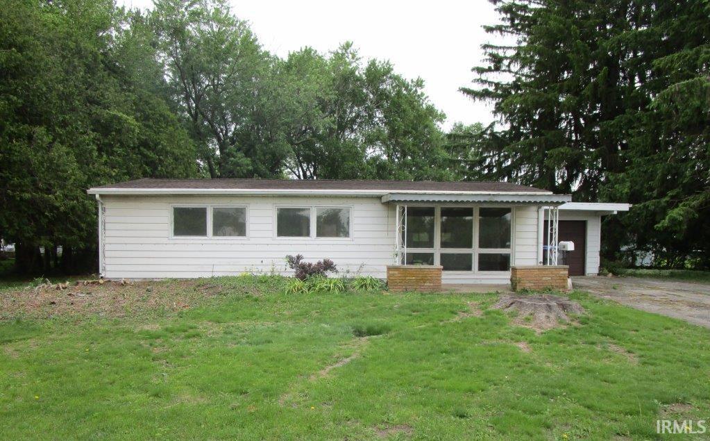 Image 1: Single-story residence featuring white siding and a brown shingle roof, Front Of Structure Image 1: Single-story residence featuring white siding and a brown shingle roof, Front Of Structure
