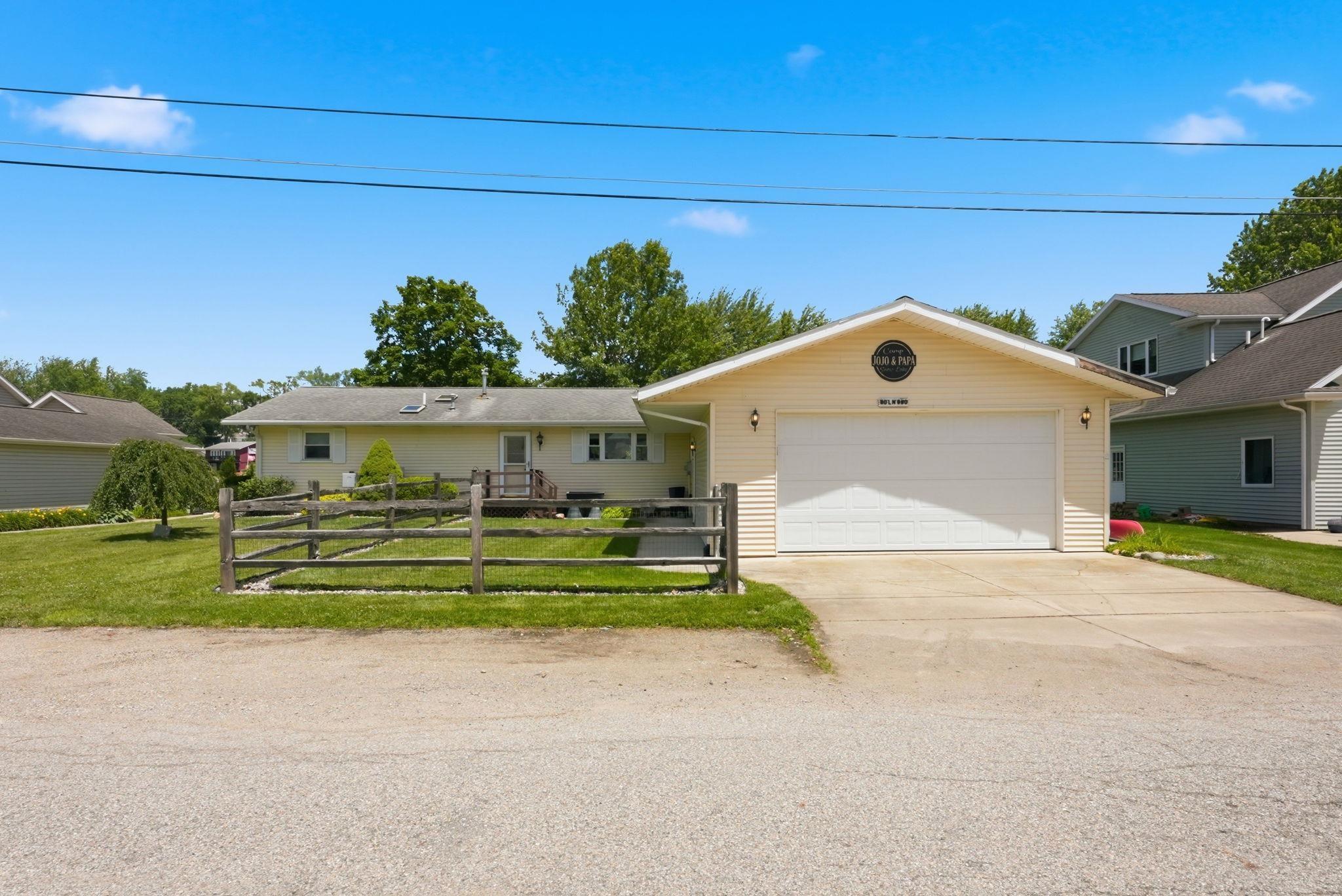 Image 1: Ranch-style exterior with light yellow siding and a white trim, Front Of Structure