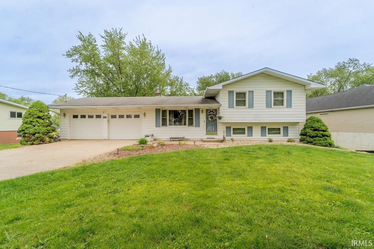 Image 0: Split-level residence featuring white siding and light blue window shutters, Front Of Structure Image 0: Split-level residence featuring white siding and light blue window shutters, Front Of Structure