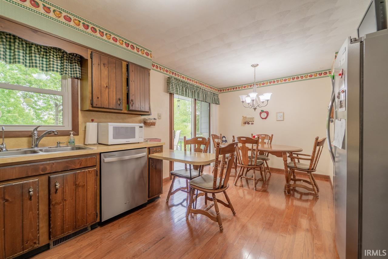 Image 3: Kitchen and dining area featuring wood-finish flooring, Kitchen Image 3: Kitchen and dining area featuring wood-finish flooring, Kitchen