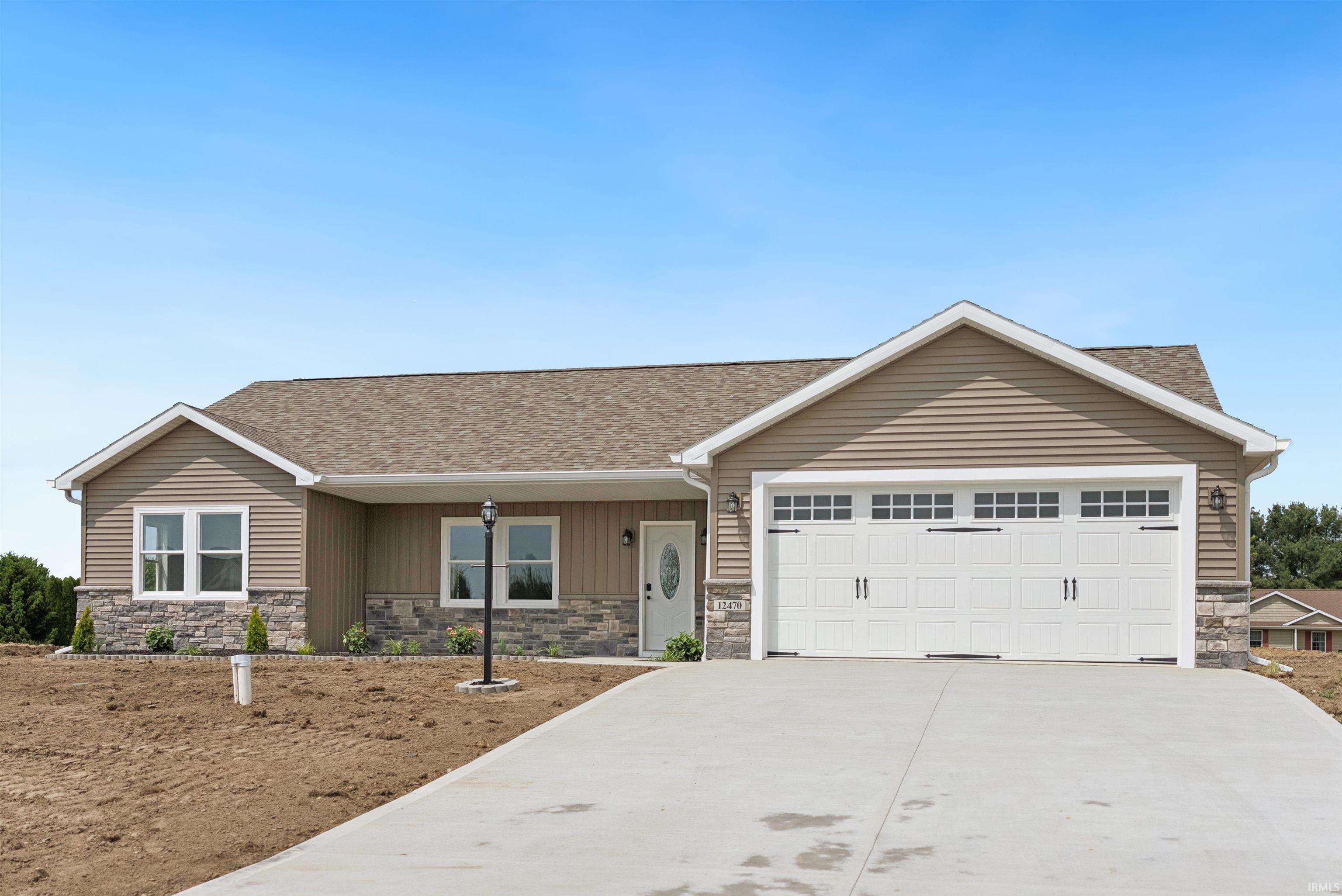 Image 0: Ranch-style residence featuring a stone veneer facade, horizontal siding, and a gabled roofline, Front Of Structure
