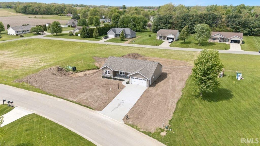 Image 3: Ranch-style residence featuring light-toned siding and a dark shingle roof, Aerial View