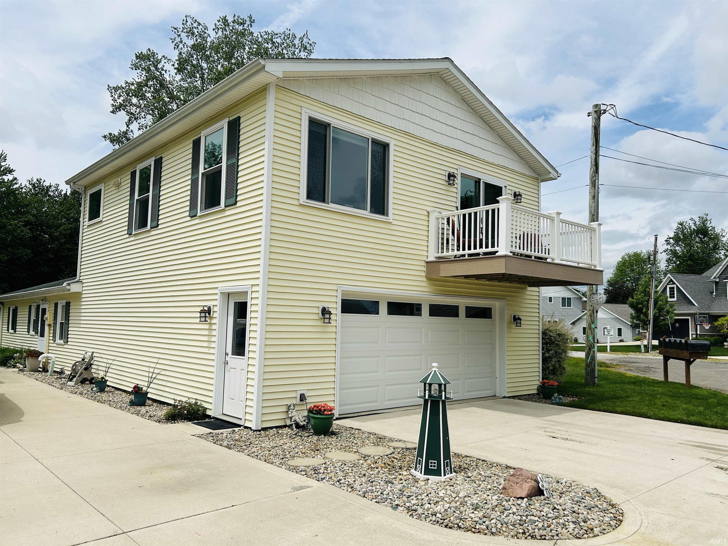 Image 0: Two-story residence featuring light yellow siding and a white trim, Side Of Structure Image 0: Two-story residence featuring light yellow siding and a white trim, Side Of Structure
