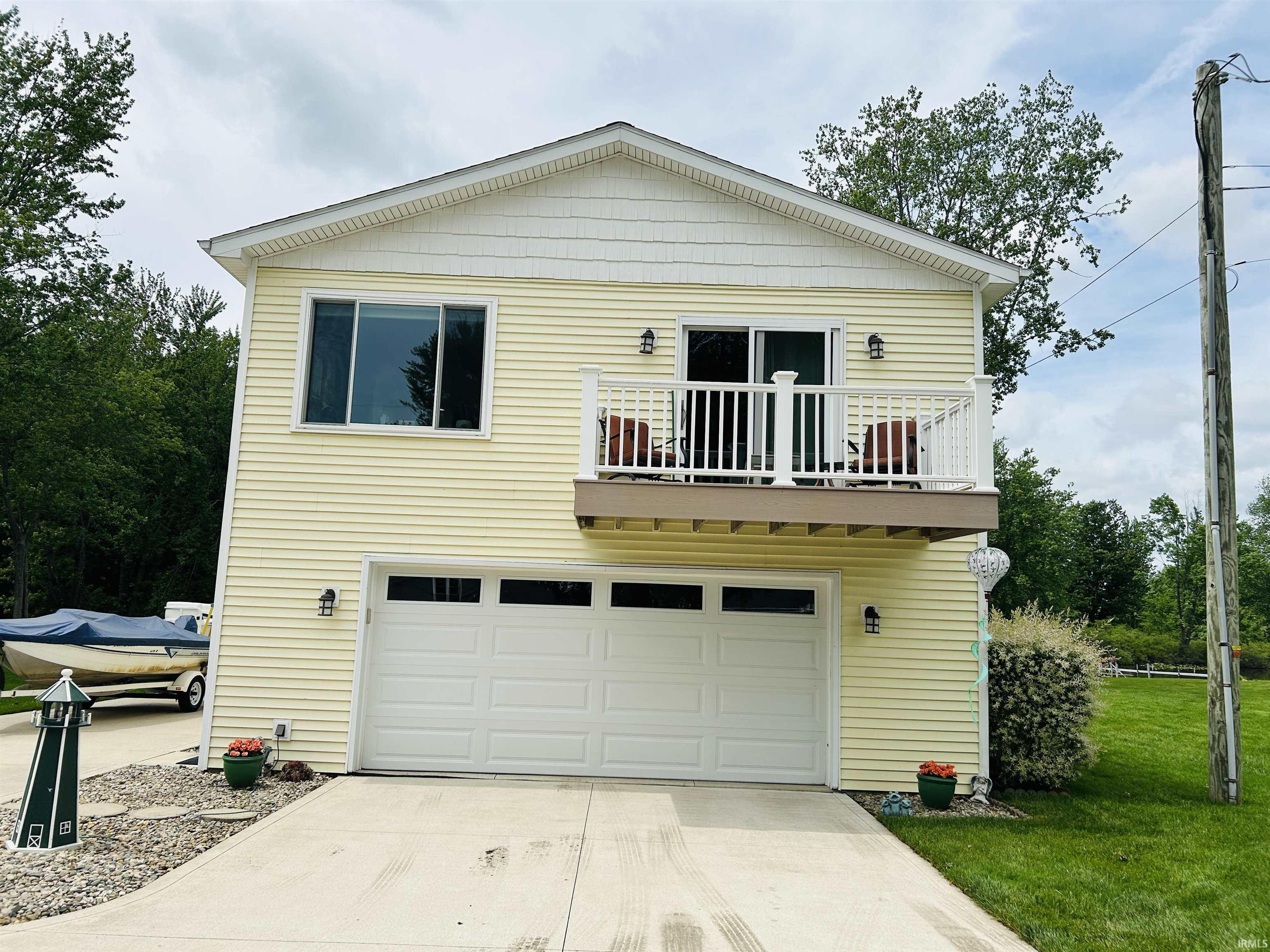 Image 1: Two-story residence featuring yellow horizontal siding and white trim, Front Of Structure Image 1: Two-story residence featuring yellow horizontal siding and white trim, Front Of Structure