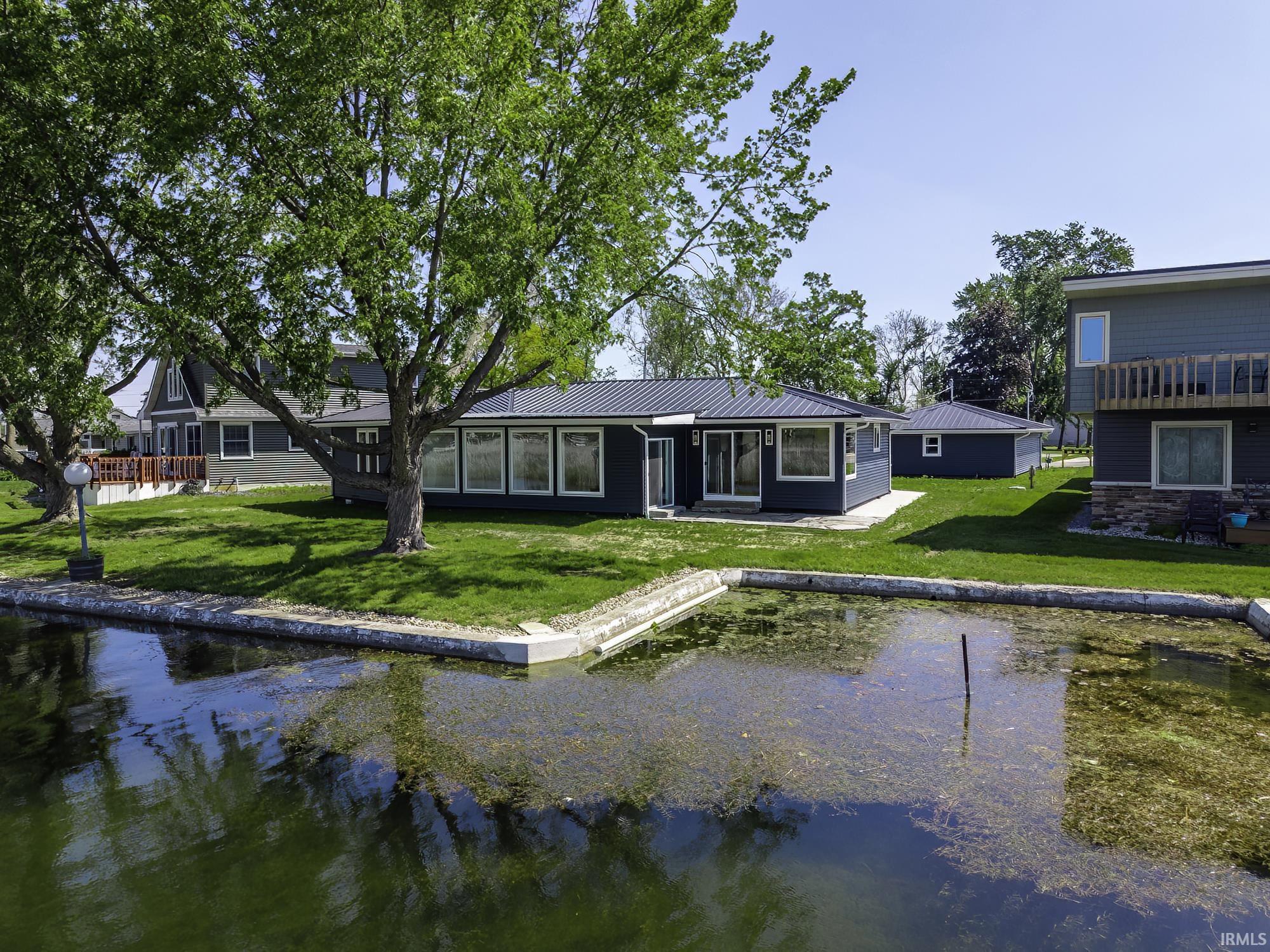 Image 3: Waterfront property featuring a dark-toned exterior with a metal roof, Back Of Structure Image 3: Waterfront property featuring a dark-toned exterior with a metal roof, Back Of Structure