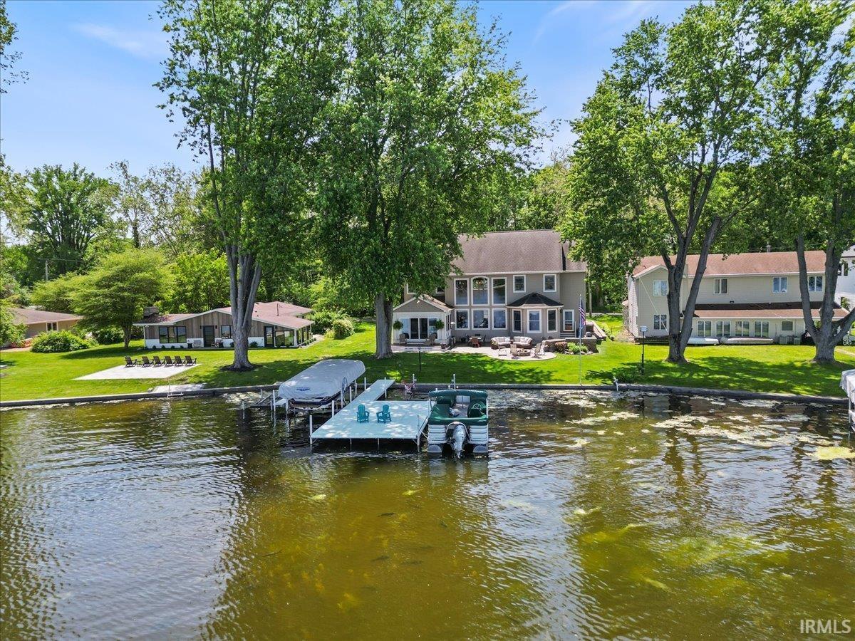 Image 0: Waterfront property featuring a private dock with boat slips, expansive green lawn, and mature trees, Lakeside Image 0: Waterfront property featuring a private dock with boat slips, expansive green lawn, and mature trees, Lakeside
