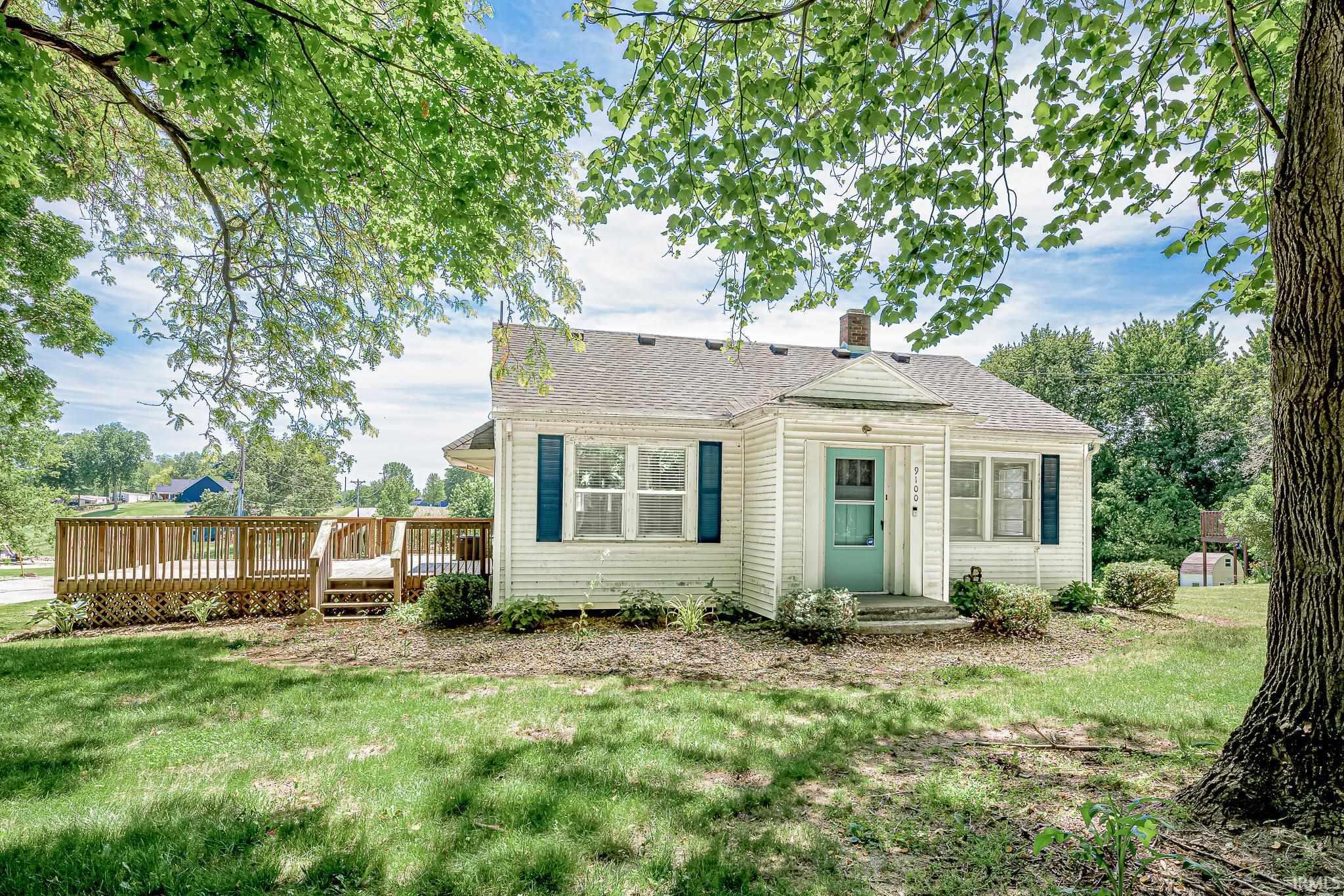 Image 1: Exterior featuring white siding, a teal entry door, and dark blue window shutters, Front Of Structure Image 1: Exterior featuring white siding, a teal entry door, and dark blue window shutters, Front Of Structure