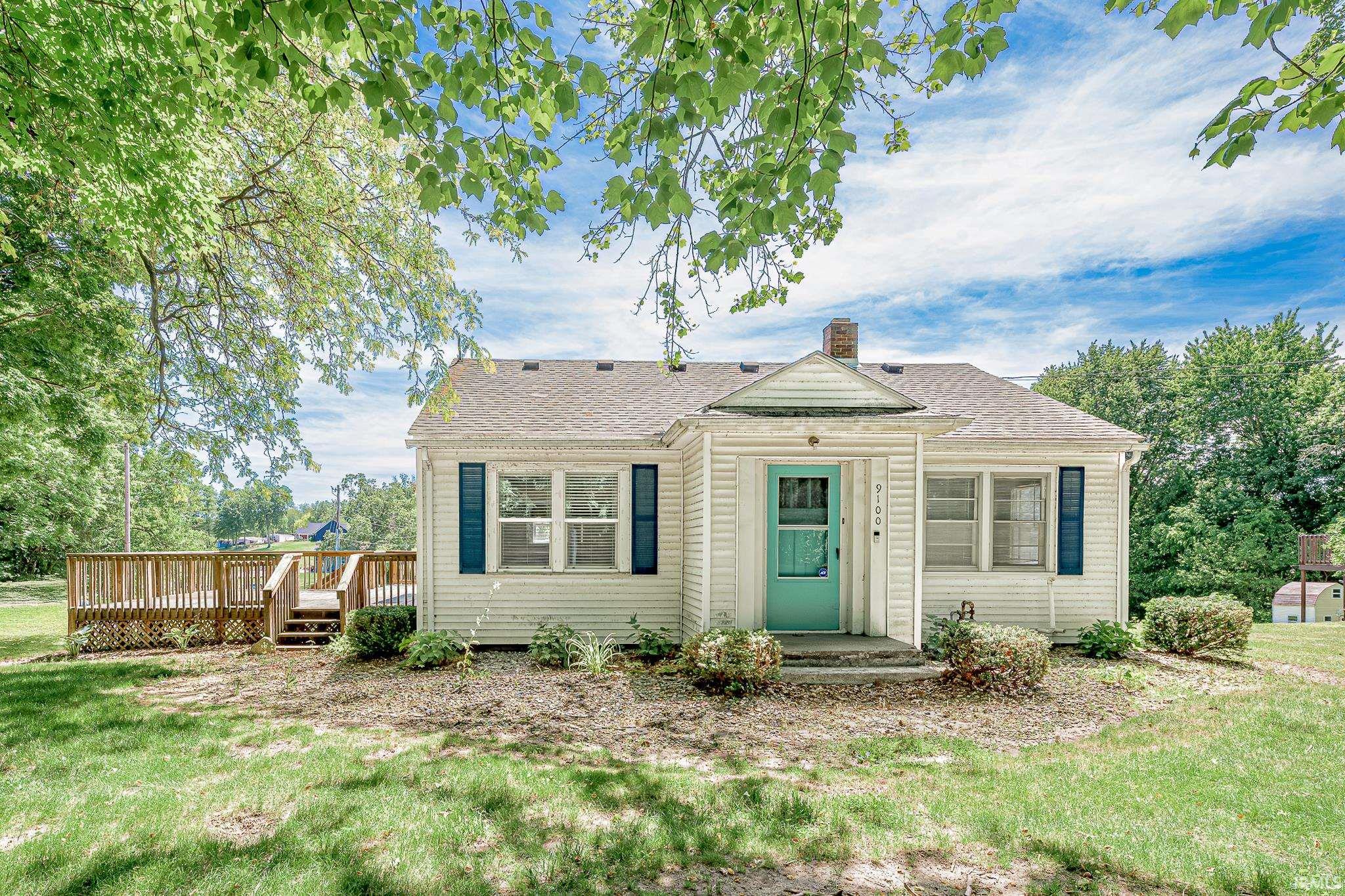 Image 2: Charming single-story residence with white siding and a turquoise front door, Front Of Structure Image 2: Charming single-story residence with white siding and a turquoise front door, Front Of Structure