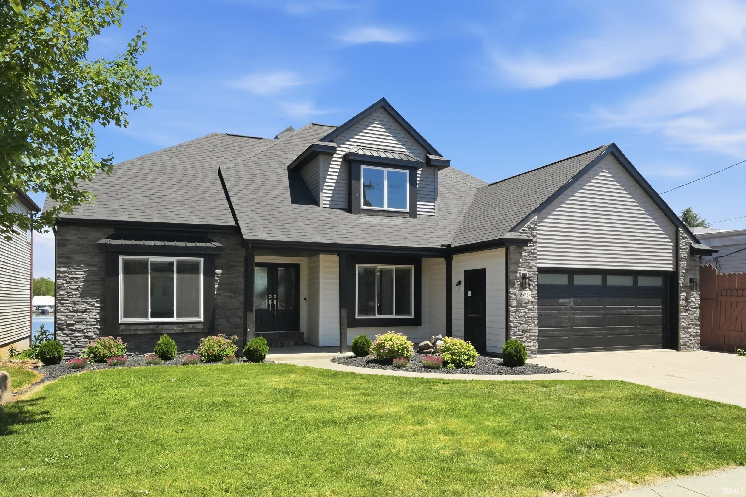 Image 1: Modern facade featuring a combination of stone veneer and siding, Front Of Structure Image 1: Modern facade featuring a combination of stone veneer and siding, Front Of Structure