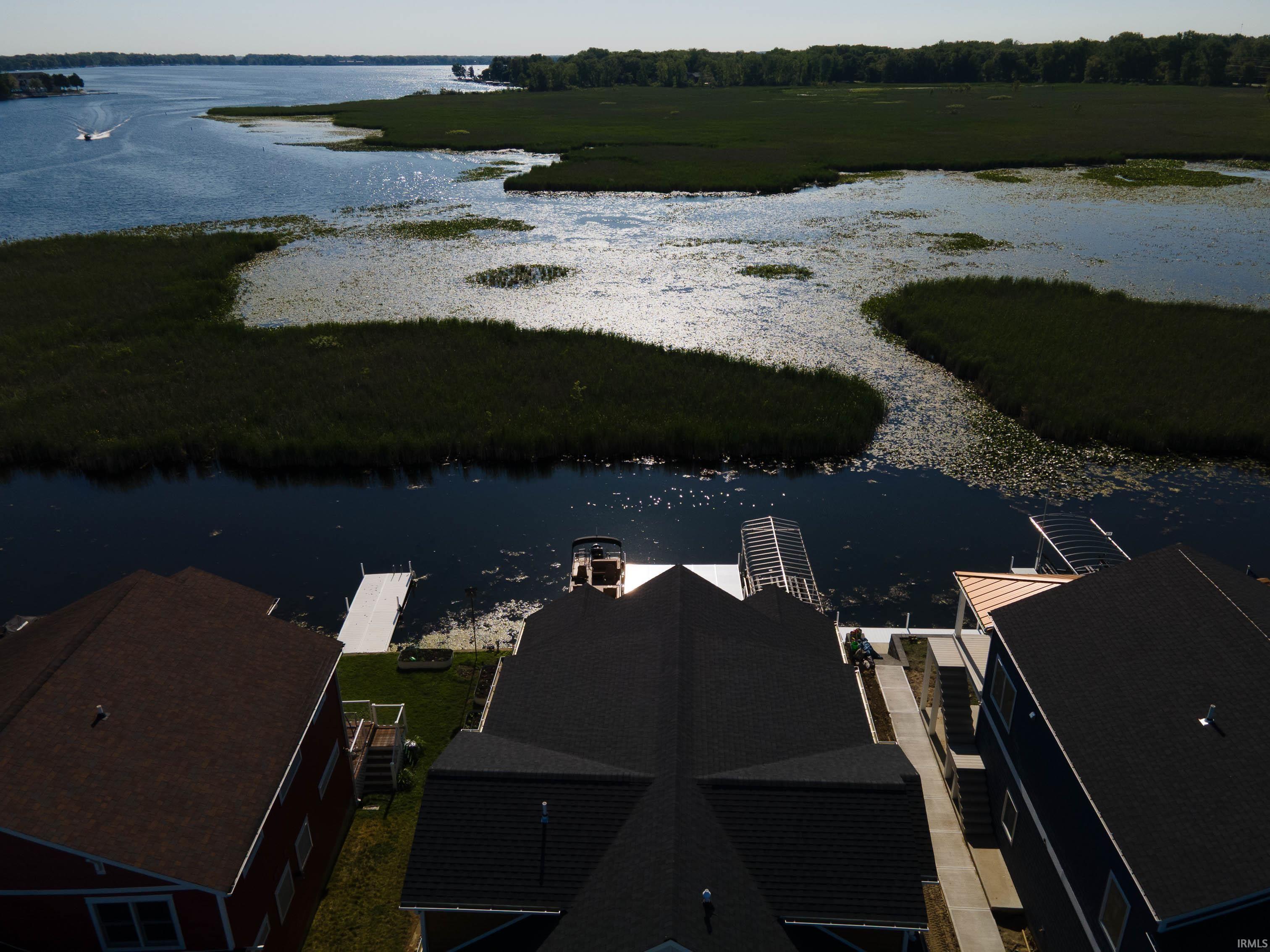 Image 1: Waterfront property featuring a private boat dock and a second dock with a boat lift, Aerial View Image 1: Waterfront property featuring a private boat dock and a second dock with a boat lift, Aerial View