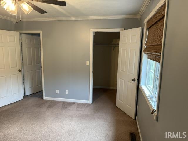 Image 3: Carpeted room with crown molding, a ceiling fan with light kit, and a window featuring a woven shade, Bedroom Image 3: Carpeted room with crown molding, a ceiling fan with light kit, and a window featuring a woven shade, Bedroom