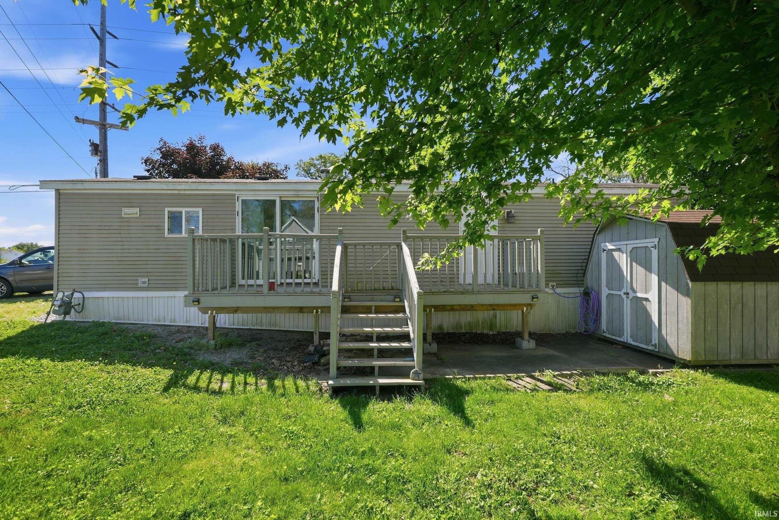 Image 1: Rear exterior featuring siding, a raised deck with railings, and sliding glass doors, Back Of Structure