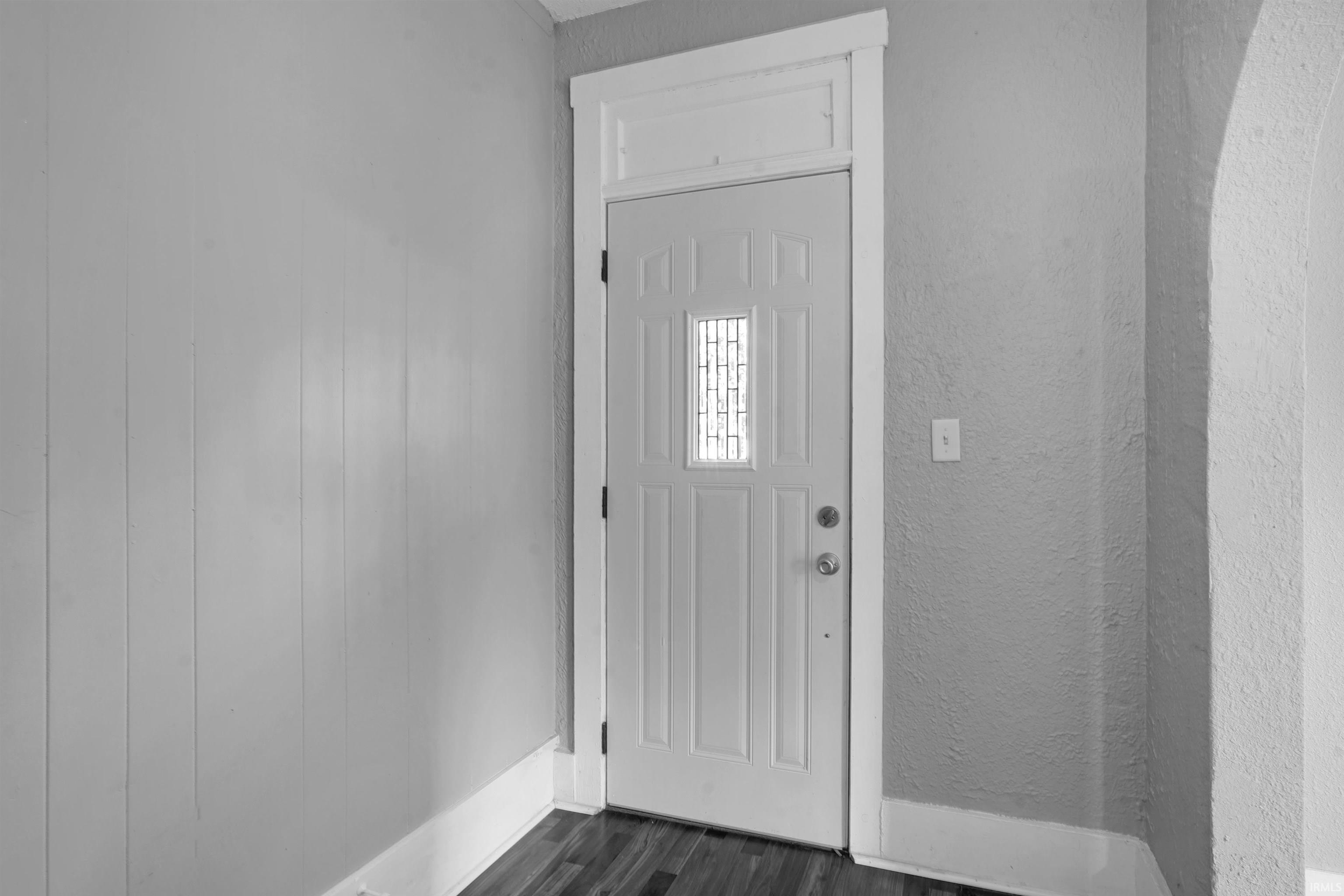 Image 2: Front entry door with decorative glass insert, paneled door design, and a transom window above, Entrance Foyer