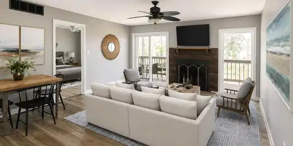Image 1: Wood-finish flooring throughout, with a ceiling fan, fireplace featuring a wood-paneled surround, and two sliding glass doors leading to an outdoor deck, Living Room Image 1: Wood-finish flooring throughout, with a ceiling fan, fireplace featuring a wood-paneled surround, and two sliding glass doors leading to an outdoor deck, Living Room