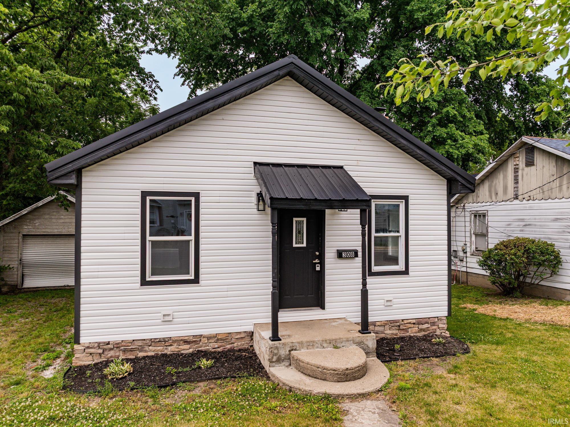 Image 0: White horizontal siding exterior with black trim and a dark metal roof, Front Of Structure Image 0: White horizontal siding exterior with black trim and a dark metal roof, Front Of Structure