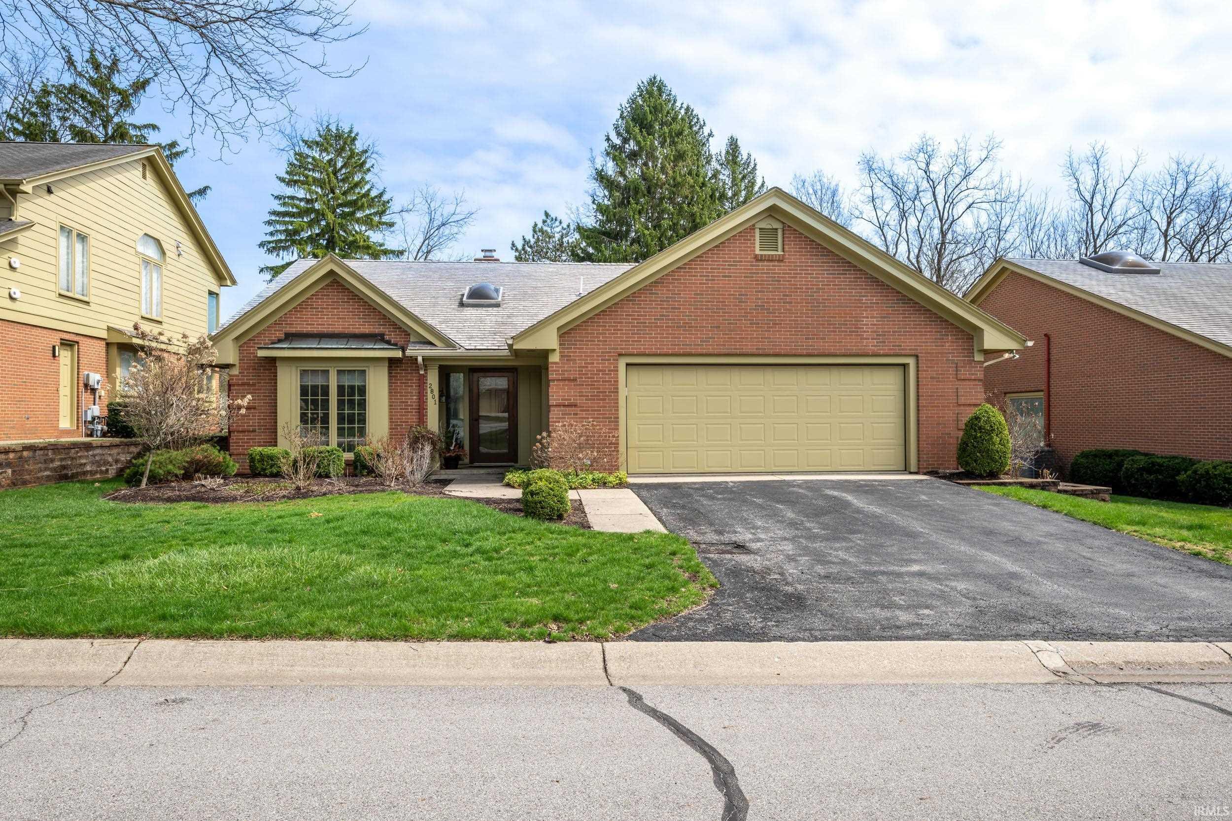 Image 1: Ranch-style house with brick siding, a garage, asphalt driveway, a front lawn, and a shingled roof, Front Of Structure Image 1: Ranch-style house with brick siding, a garage, asphalt driveway, a front lawn, and a shingled roof, Front Of Structure