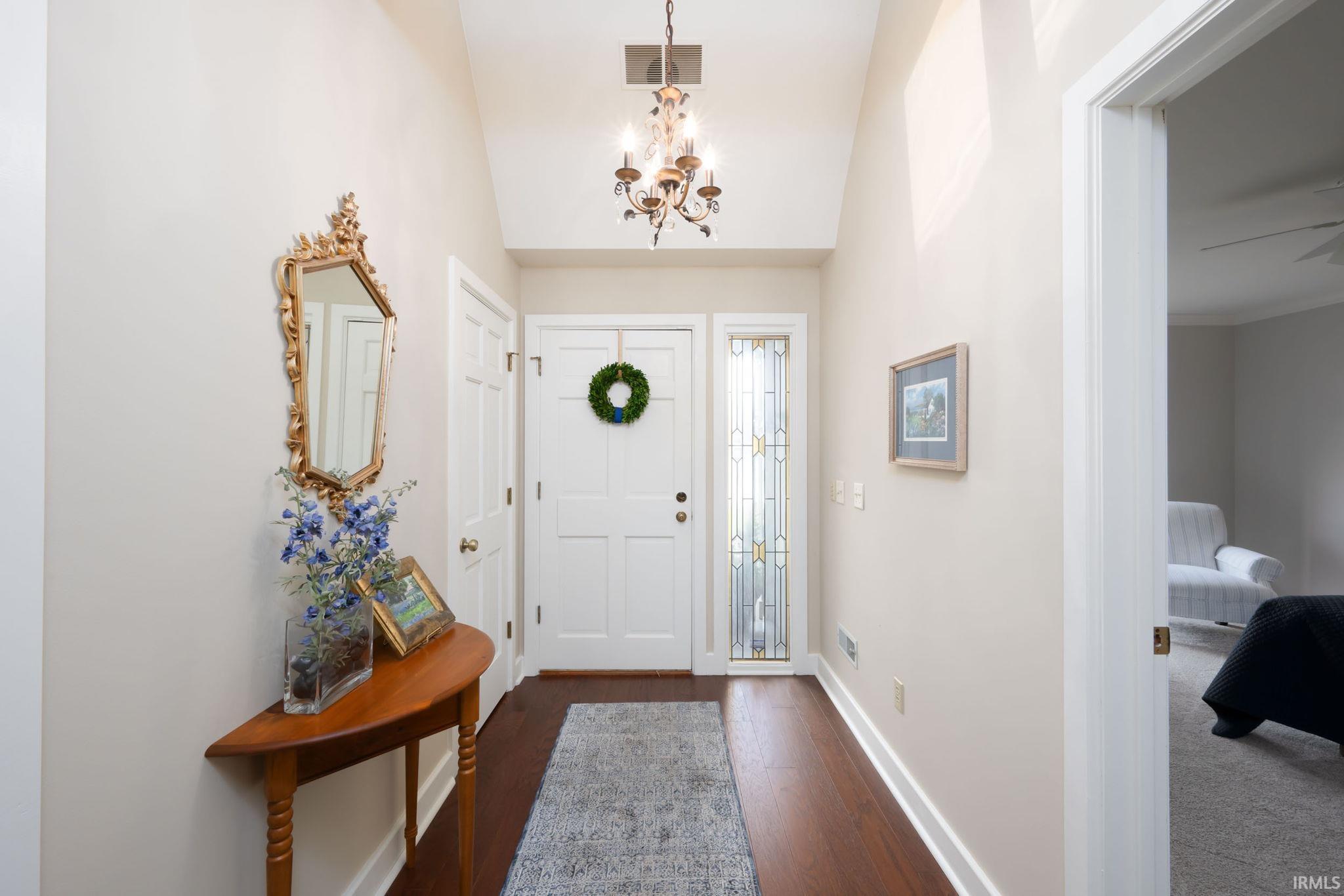 Image 3: Foyer featuring lofted ceiling, dark wood-style flooring, and suspended lighting, Entrance Foyer Image 3: Foyer featuring lofted ceiling, dark wood-style flooring, and suspended lighting, Entrance Foyer