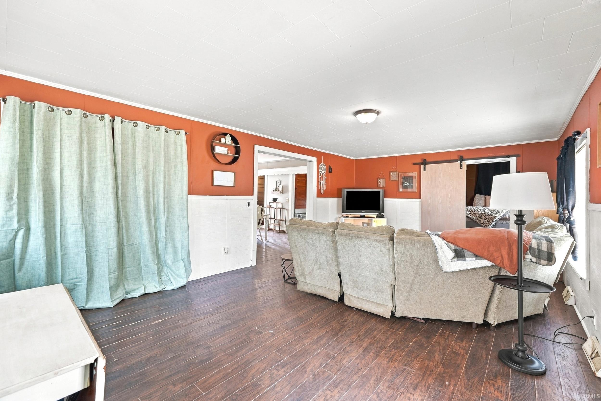 Image 3: Living area with wood-finish flooring and a white ceiling, Living Room Image 3: Living area with wood-finish flooring and a white ceiling, Living Room