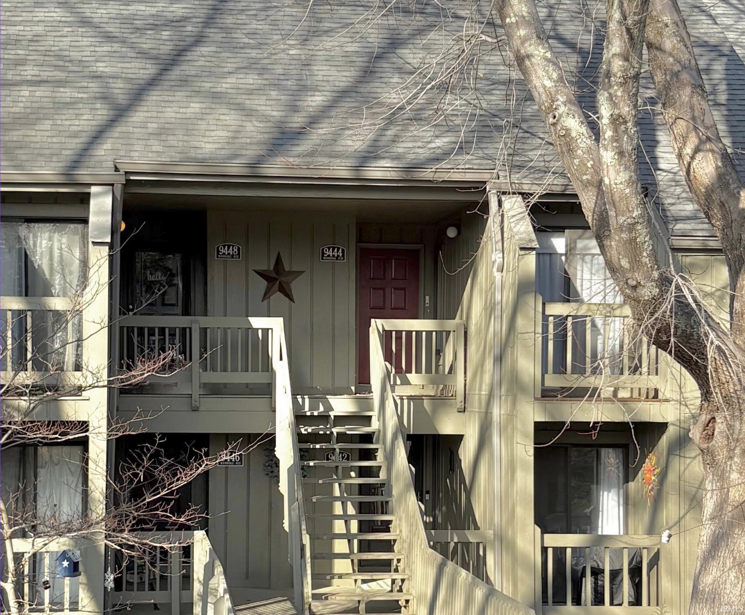 Image 0: Doorway to property featuring a shingled roof and a porch, Entry