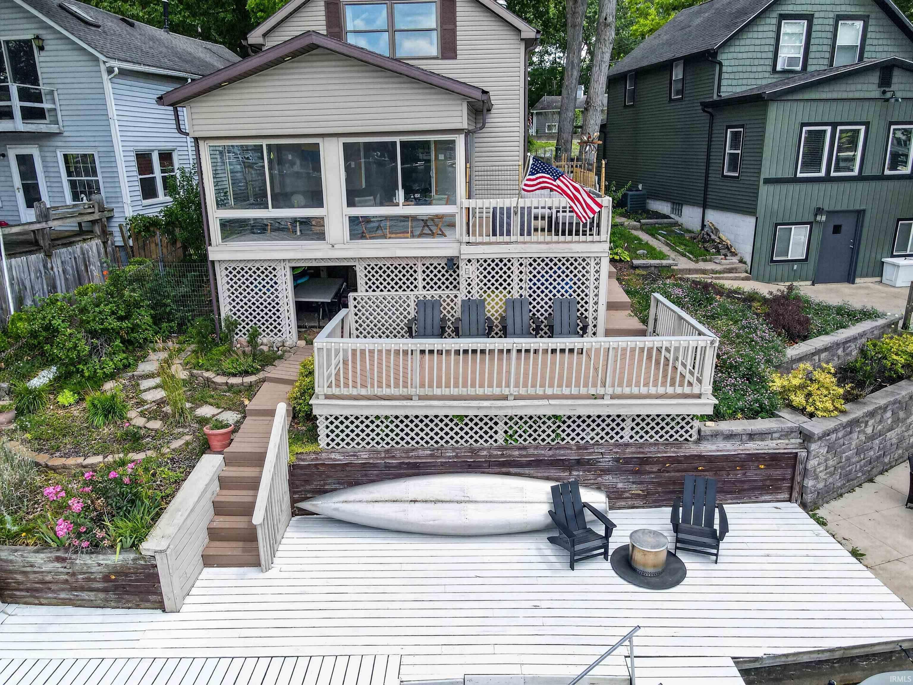 Image 2: Multi-level rear deck with white lattice skirting and natural wood steps, Back Of Structure