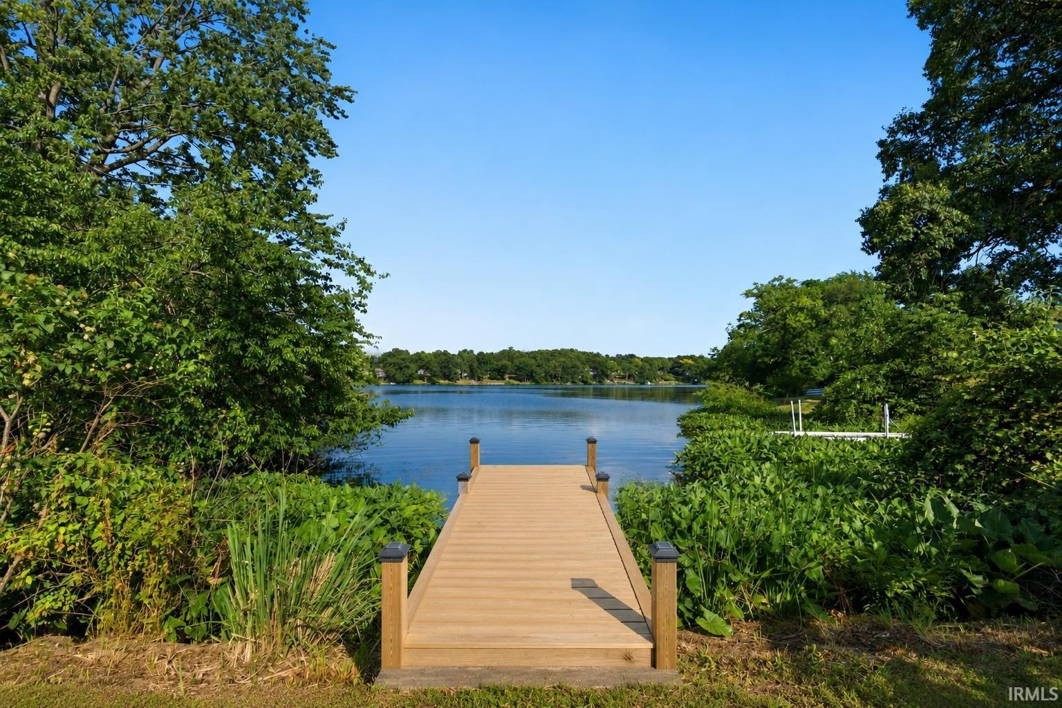 Image 1: Wood-finish dock extending over calm waters, Dock Image 1: Wood-finish dock extending over calm waters, Dock