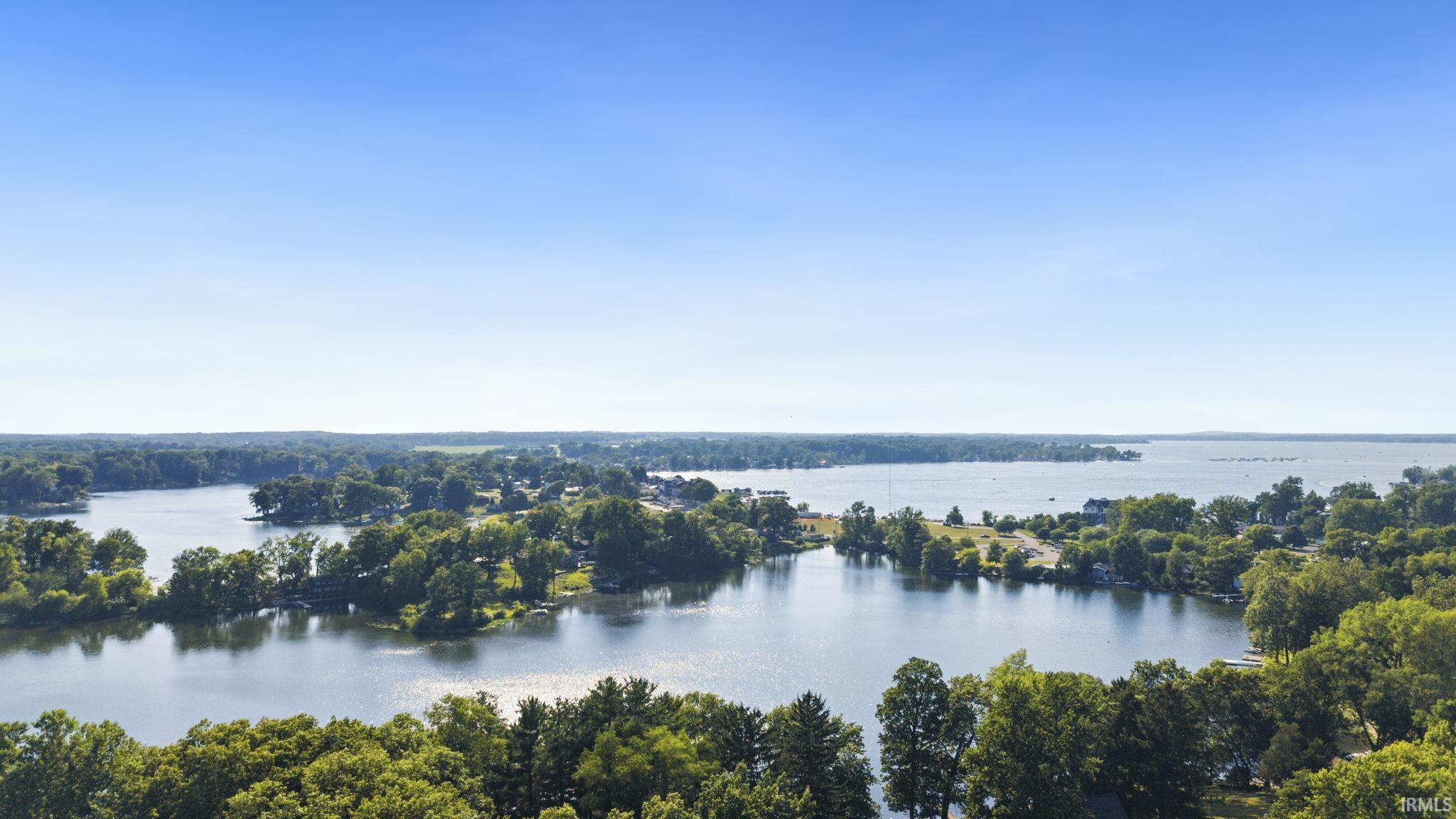 Image 3: Expansive aerial perspective showcasing a lakefront property with surrounding water features and lush green trees, View Image 3: Expansive aerial perspective showcasing a lakefront property with surrounding water features and lush green trees, View