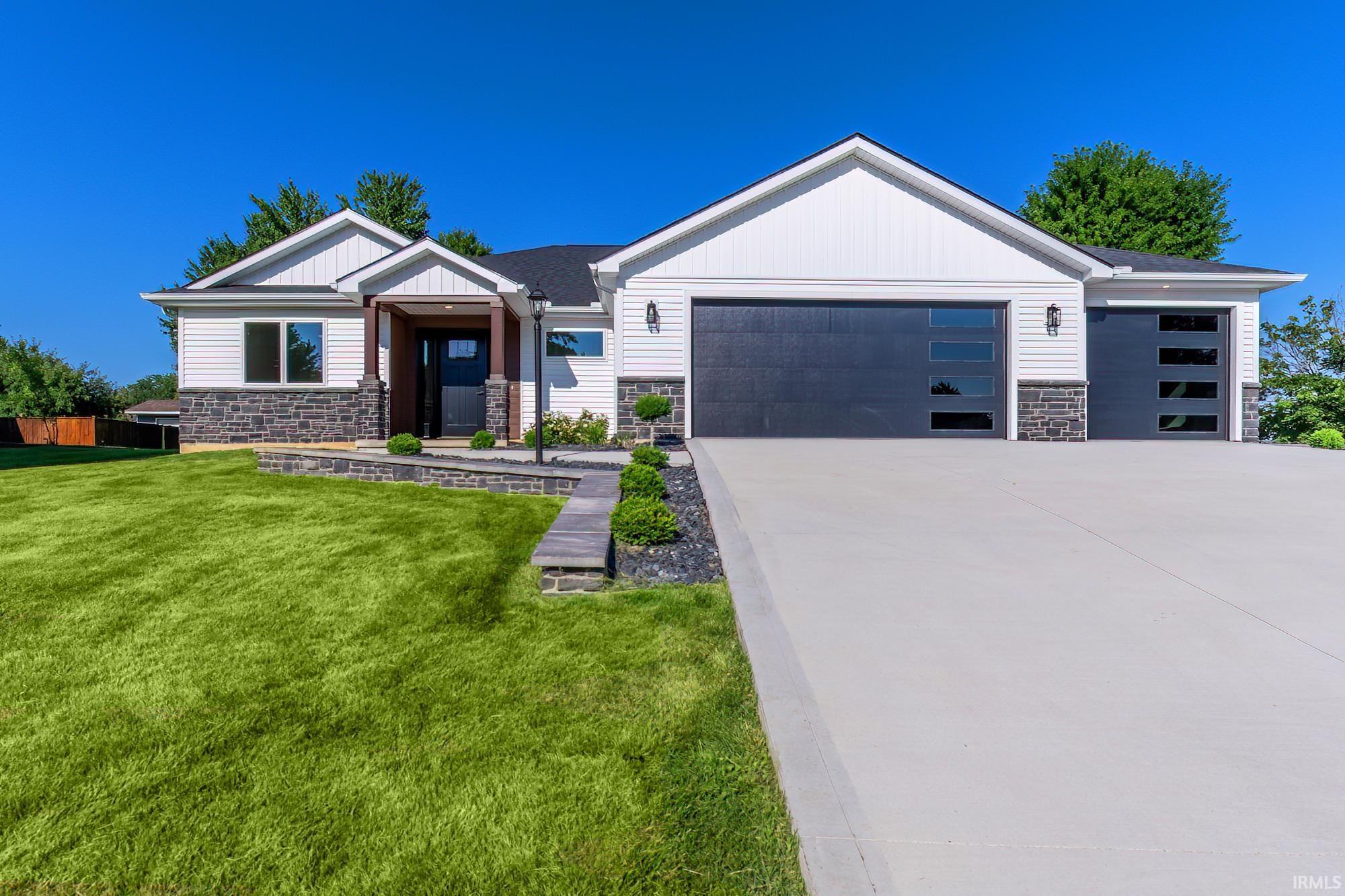Image 3: Contemporary single-story residence featuring white siding and dark stone veneer accents, Front Of Structure Image 3: Contemporary single-story residence featuring white siding and dark stone veneer accents, Front Of Structure