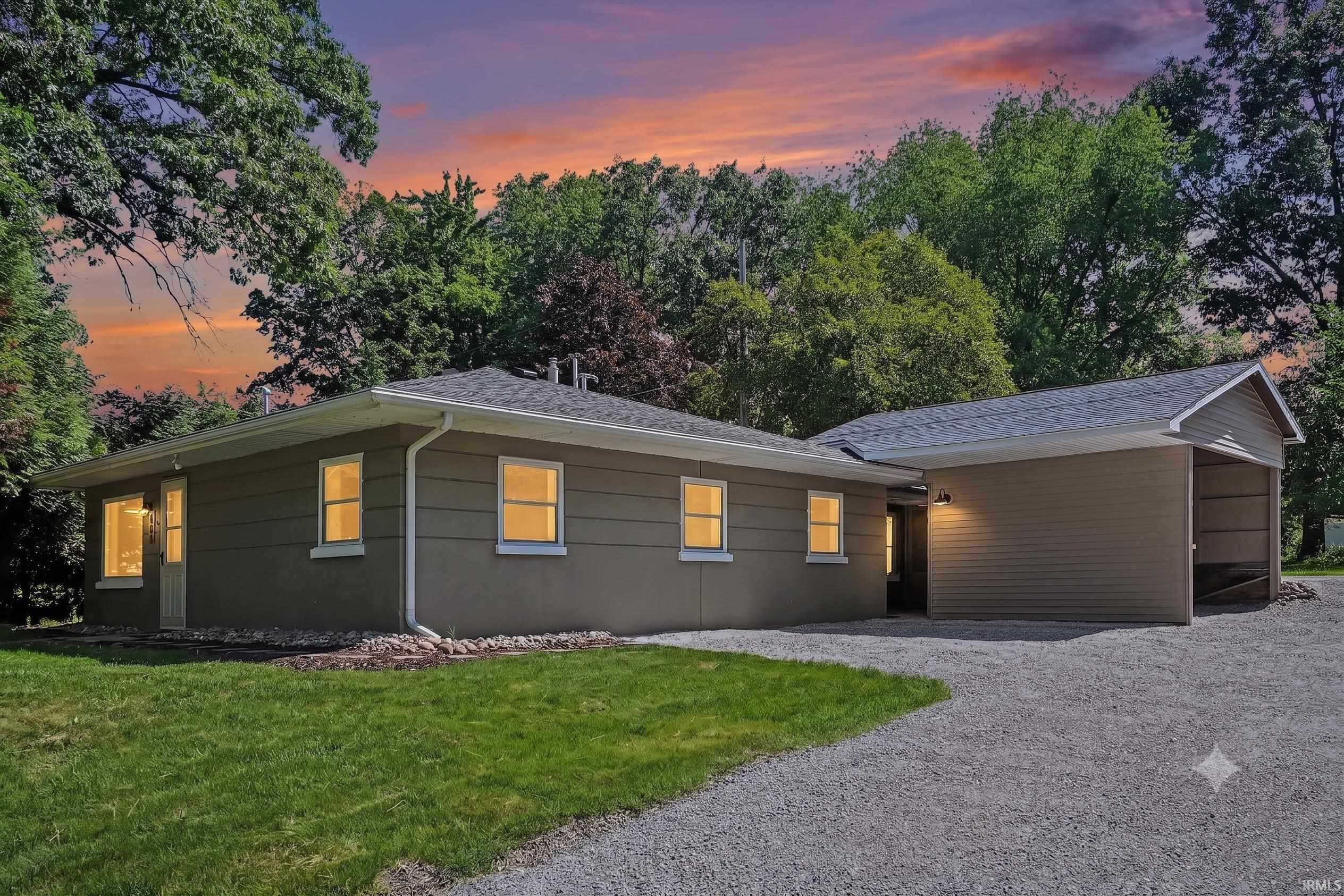 Image 0: Ranch-style exterior with neutral siding and white trim, Front Of Structure