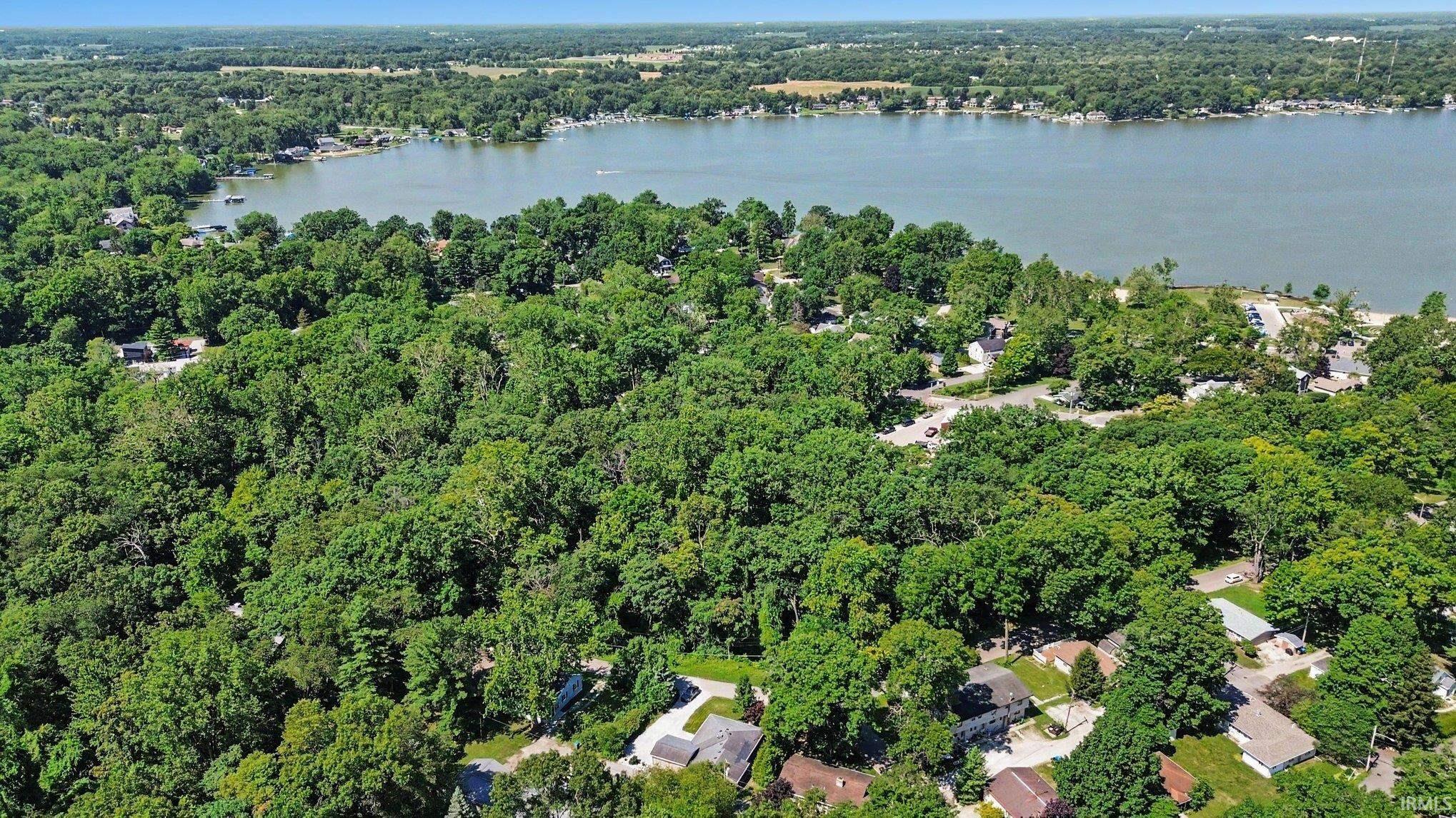 Image 2: Expansive wooded landscape featuring mature trees, Aerial View
