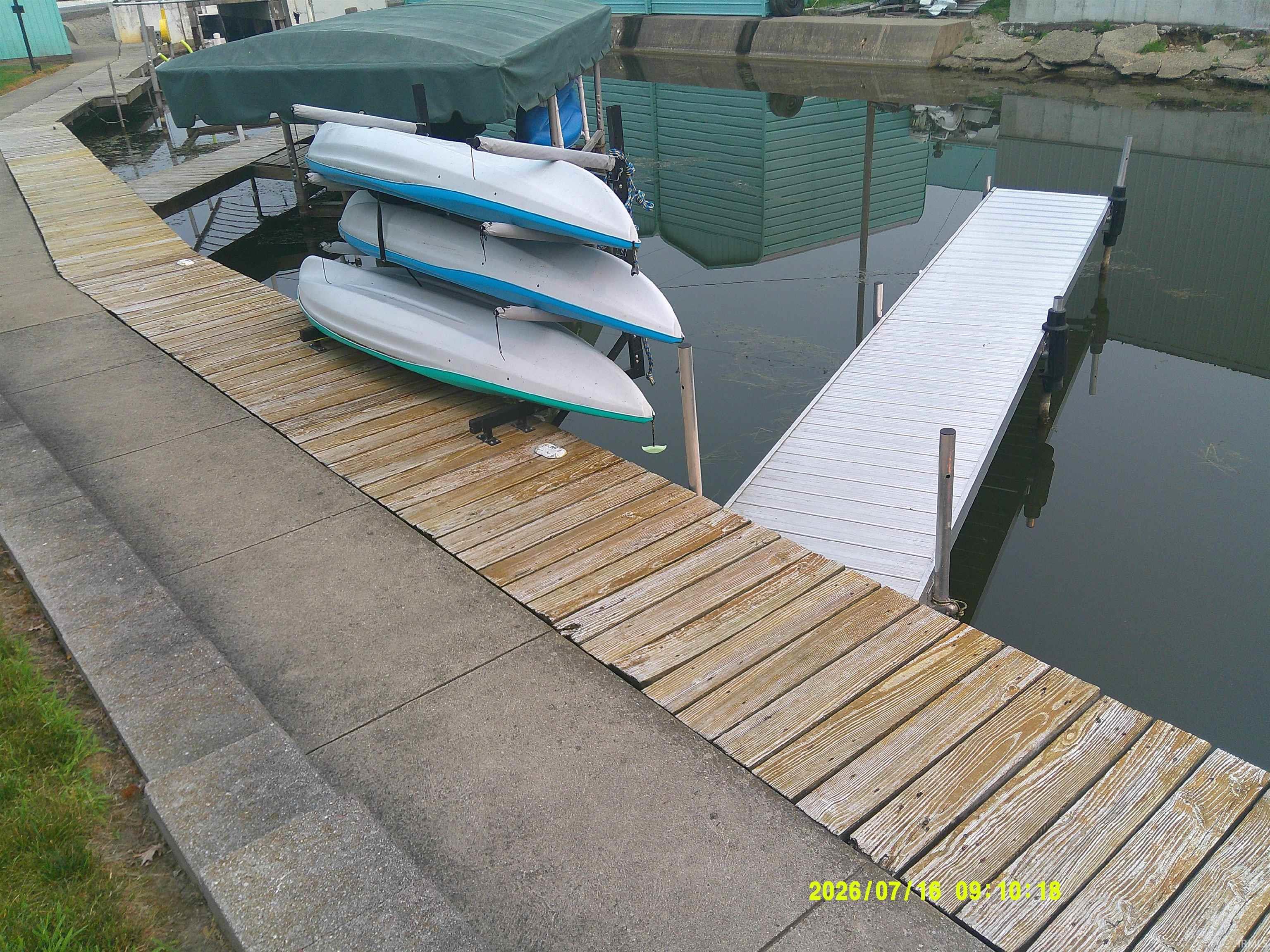 Image 1: Wood dock with concrete bordering, featuring a floating metal gangway, Dock Image 1: Wood dock with concrete bordering, featuring a floating metal gangway, Dock