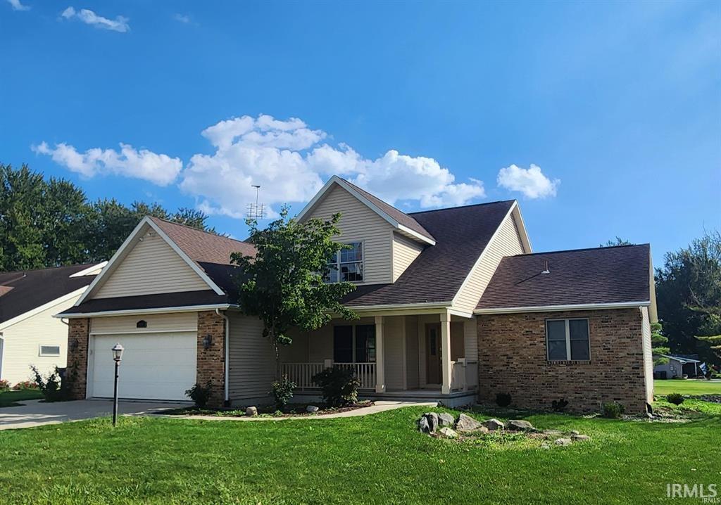 Image 0: View of front facade featuring brick siding, a porch, a front yard, and concrete driveway, Front Of Structure Image 0: View of front facade featuring brick siding, a porch, a front yard, and concrete driveway, Front Of Structure
