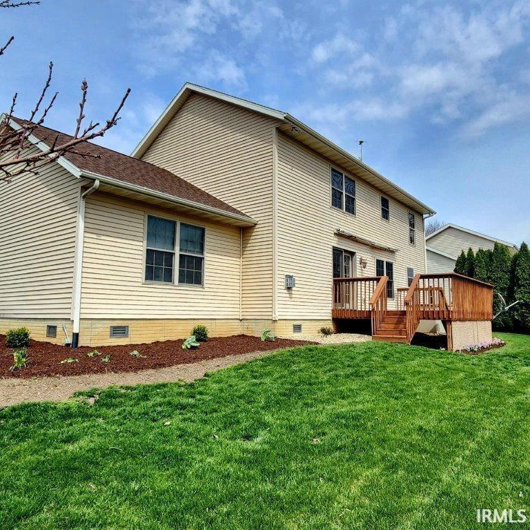 Image 1: Back of house featuring crawl space, a wooden deck, and a lawn, Back Of Structure Image 1: Back of house featuring crawl space, a wooden deck, and a lawn, Back Of Structure